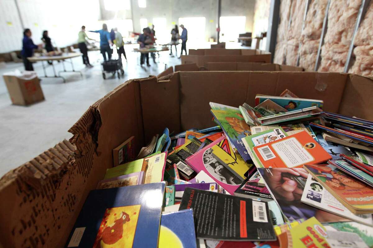 Gently used books wait to be sifted through by volunteers. The nearly 70,000 books will then be given to selected Houston ISD underprivileged students.