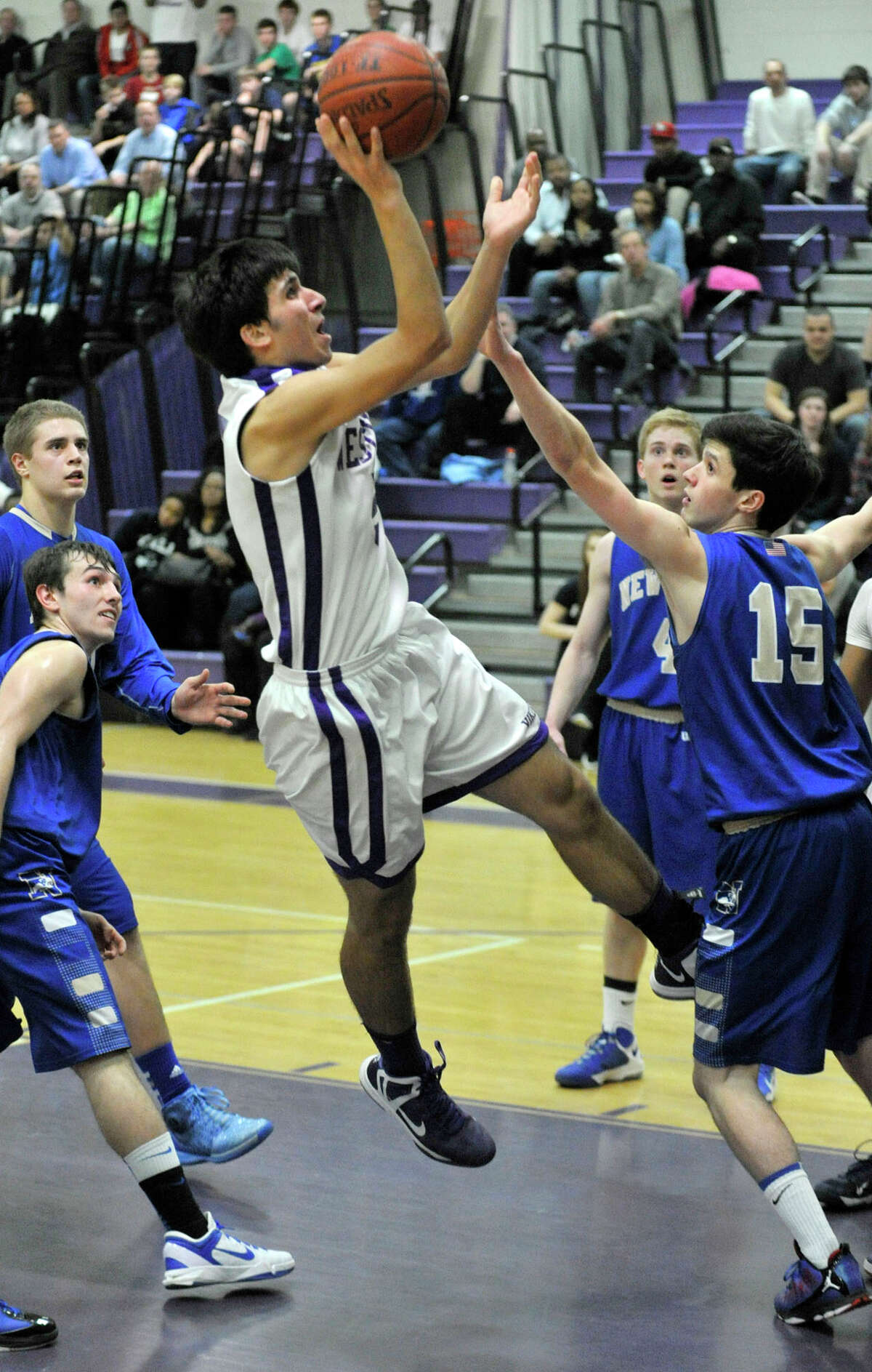 Westhill's Evan Skoparantzas shoots a fade-away jumper in front of Newtown's Gavin Scallon during their game at Westhill High School on Wednesday, March 6, 2013.
