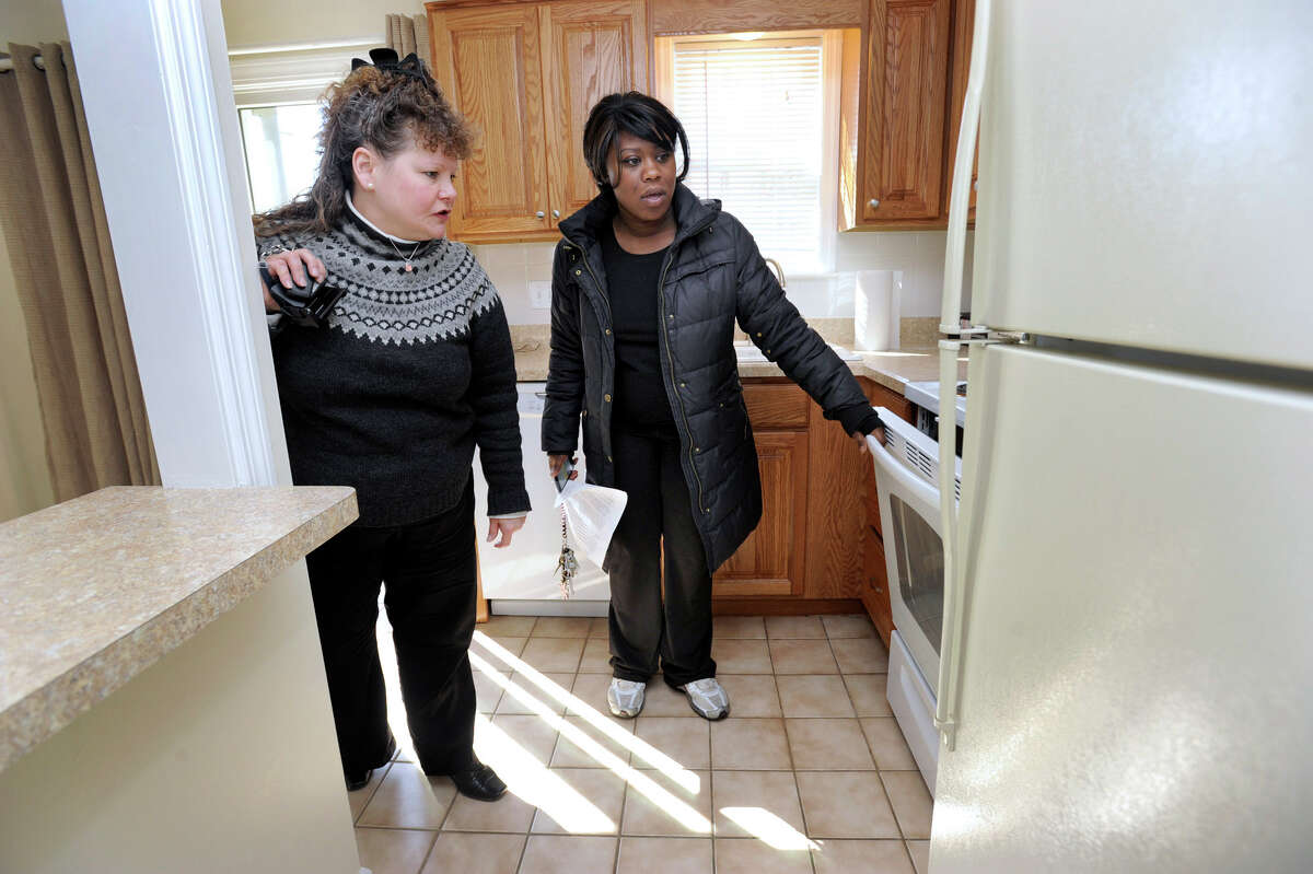 Carolyn Ridenour, 47, left, a Realtor with Prudential Connecticut Realty, shows Ranisha Green, 25, of Danbury, an apartment for rent at Racing Brook Meadow 1 in Danbury, Conn. Tuesday, March 5, 2013