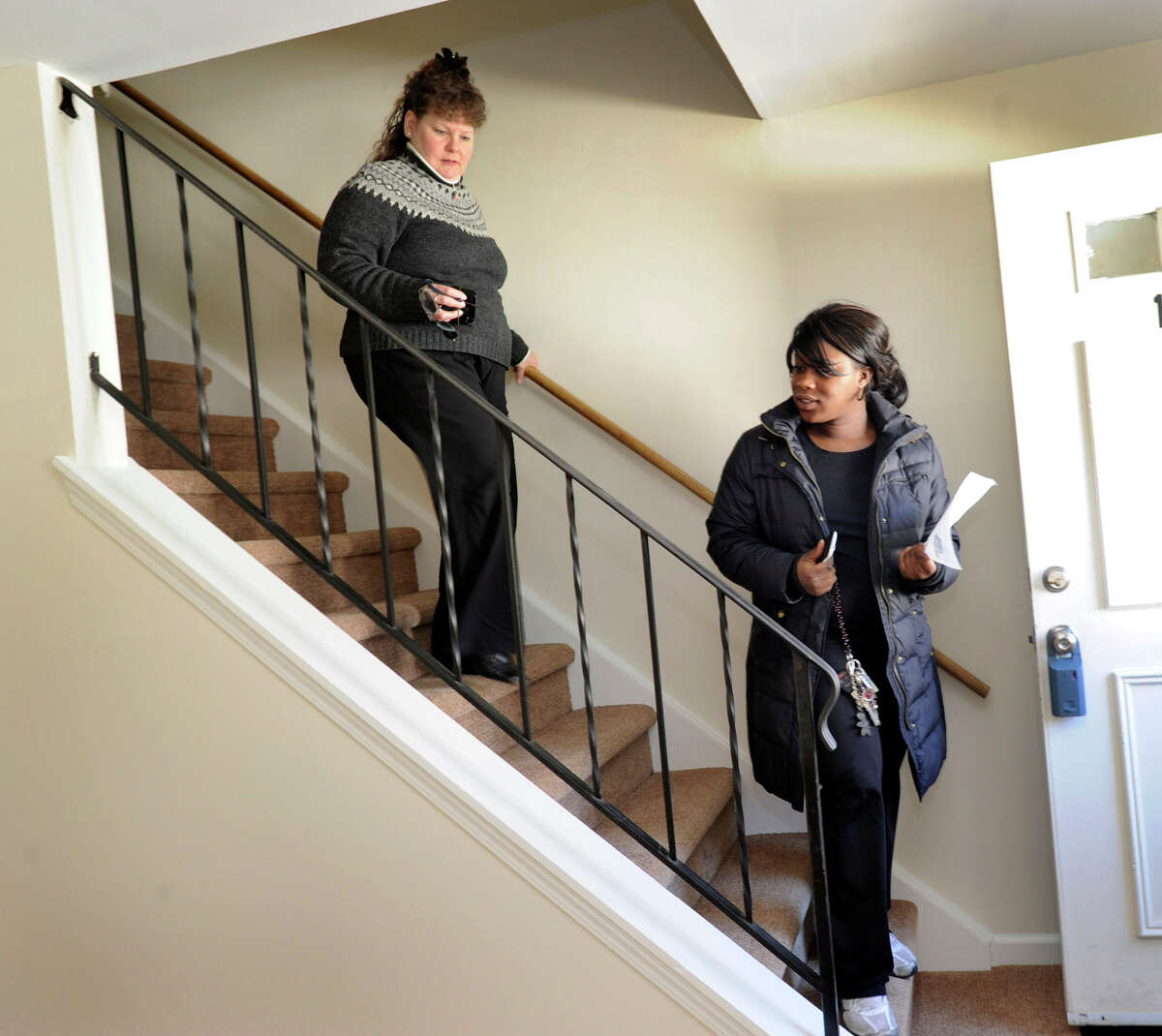 Carolyn Ridenour, 47, left, of Prudential Connecticut Realty, shows Ranisha Green, 25, of Danbury, an apartment for rent at Racing Brook Meadow 1 in Danbury, Conn. Tuesday, March 5, 2013