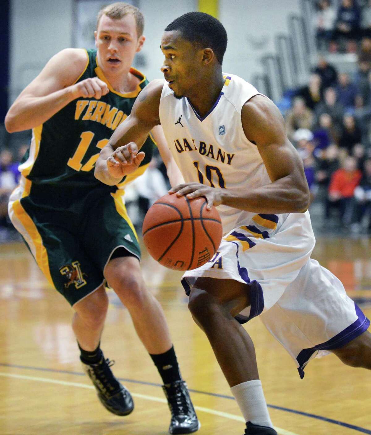 UAlbany's #10 Mike Black drives past Vermont's #12 Sandro Carissimo, at left, during an America East game at Sefcu Arena in Albany Saturday Jan. 26, 2013. (John Carl D'Annibale / Times Union)