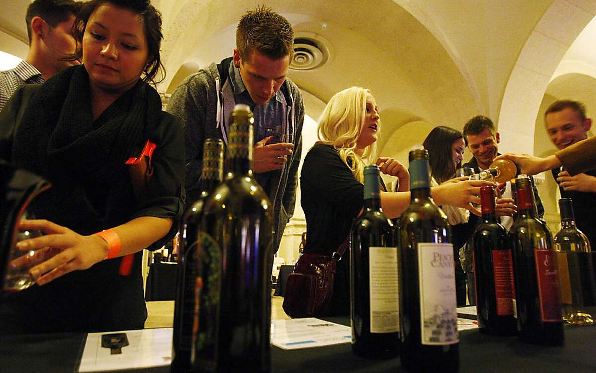 Wine Riot, a wine-tasting event focused on millennials, is helping push wine sales to new records. Events like this one in Los Angeles, California, are being held around the U.S., complete with crash seminars on wine, fake tatoos, deejays and photo booths. (Luis Sinco/Los Angeles Times/MCT)
