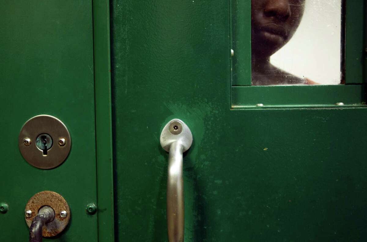 A female inmate is locked up in an acute mental health cell block at the Harris County Sheriff's Office Mental Health Unit.