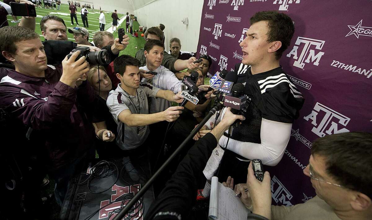 A&M QB Johnny Manziel (right) has a new offensive coordinator, but the Aggies don't expect a whole lot of changes on the field.