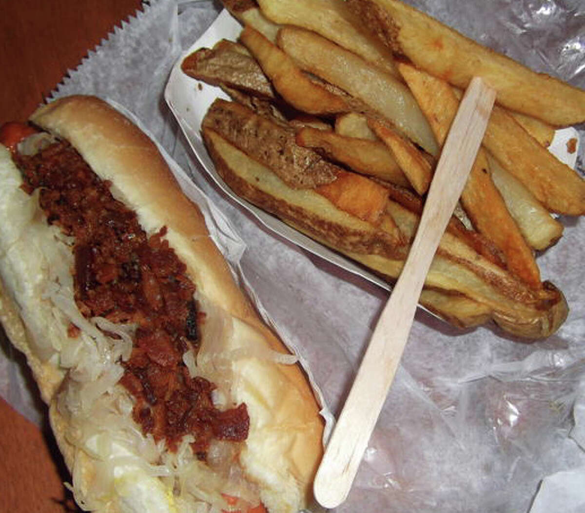 A Rawley's hot dog with fries, complete with a small wooden fork.