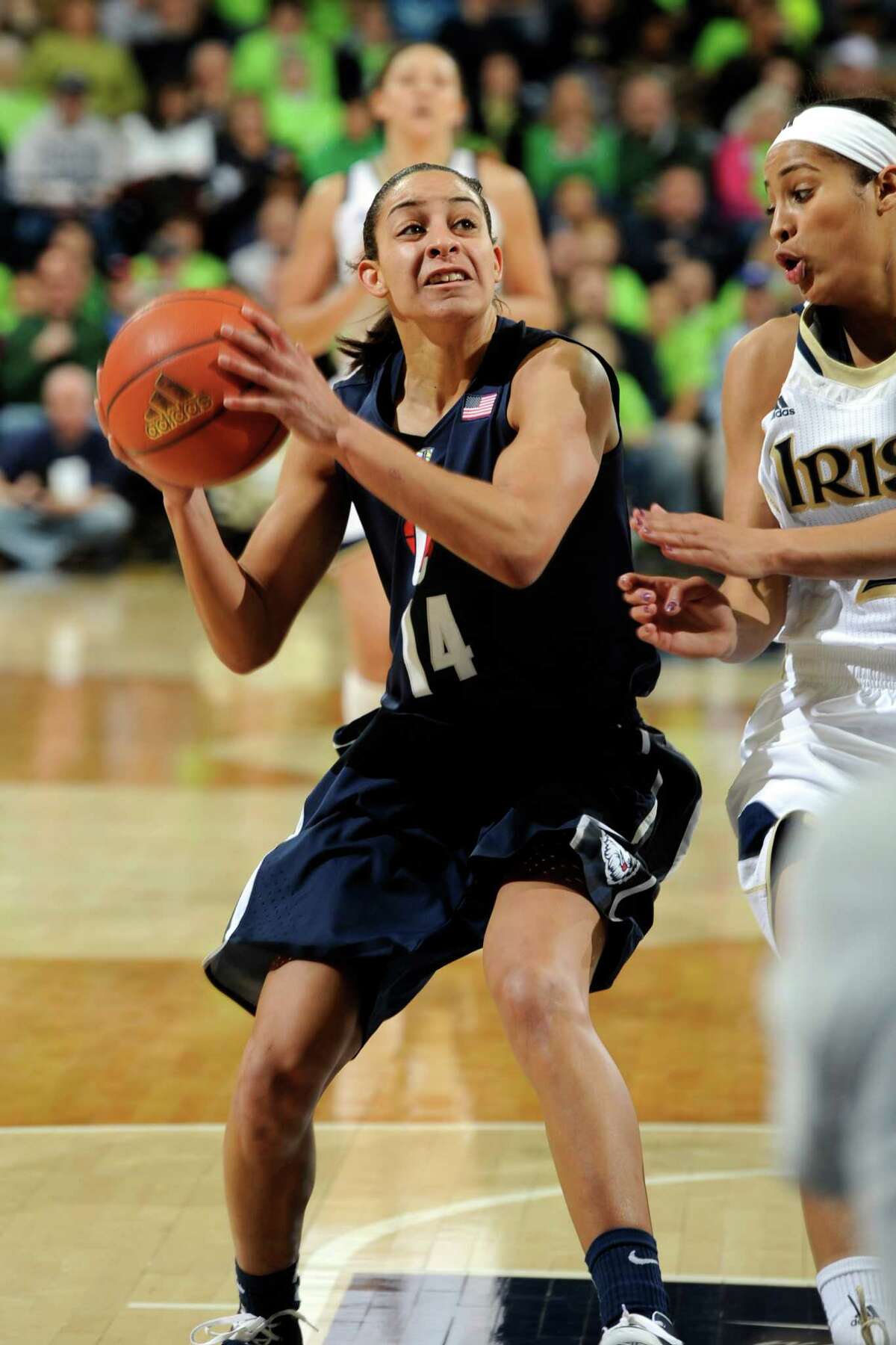 Connecticut guard Bria Hartley, left, heads up court as Notre Dame guard Skylar Diggins defends during action in a college basketball game Monday March 4, 2013 in South Bend, Ind. (AP Photo/Joe Raymond)