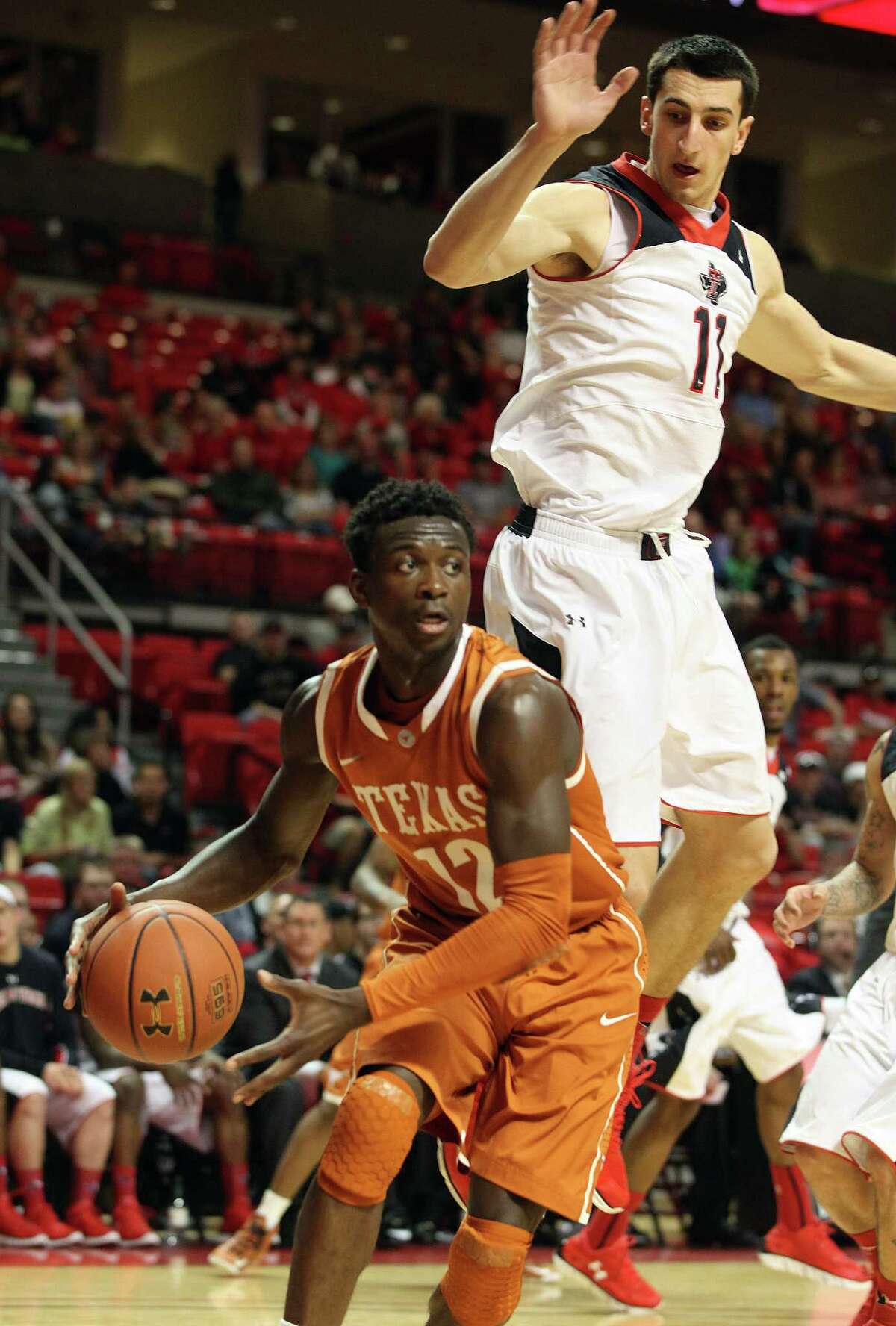 Texas guard Myck Kabongo, driving past Texas Tech's Dejan Kravic, was 0 for 12 from the field, but he made seven free throws and had four assists.