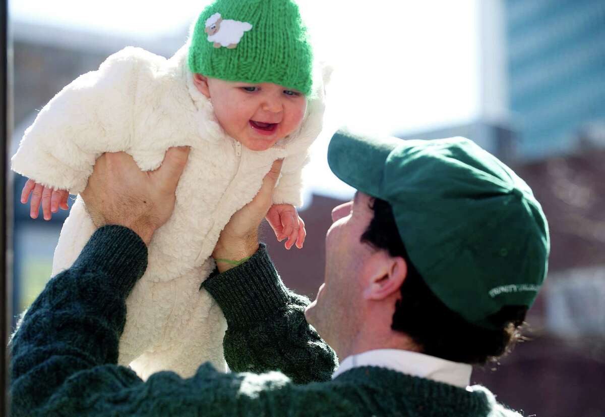 Paul Curtin plays with 7-month-old Quinn before Saturday's Saint Patrick's Day parade in Stamford, Conn., on March 9, 2013.