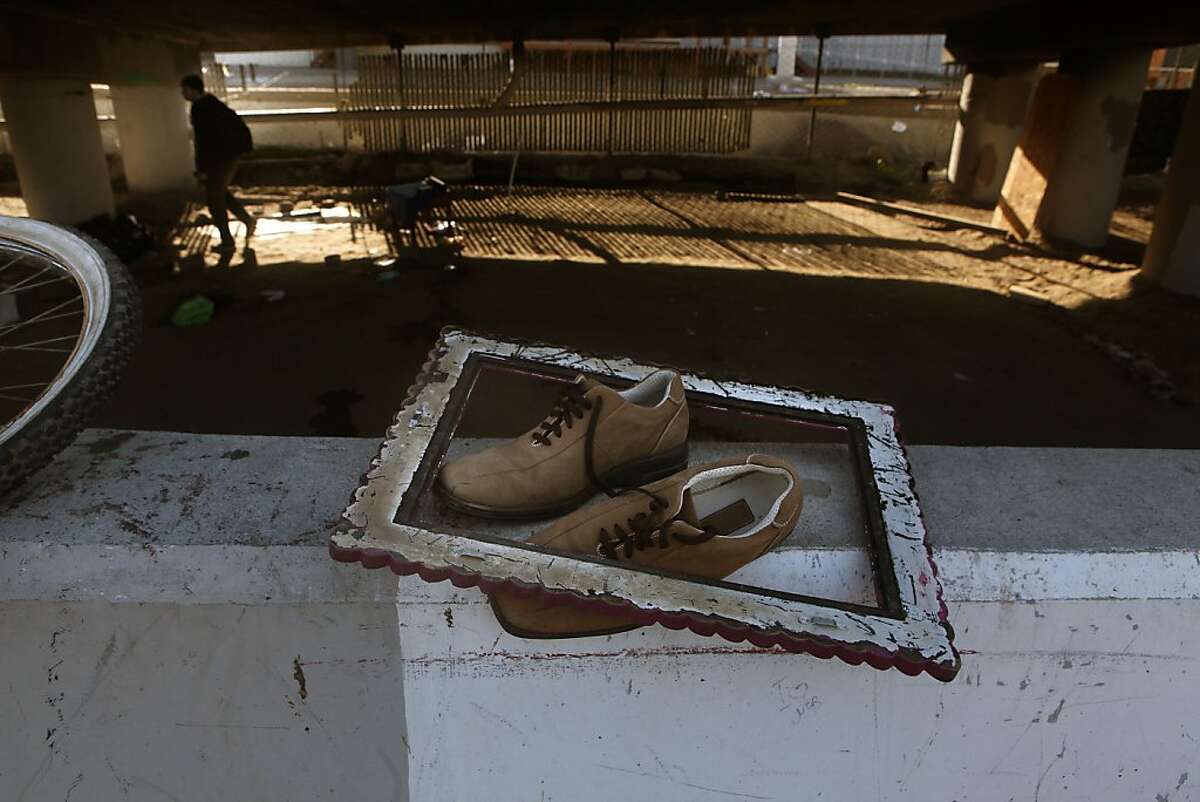 A pair of shoes and a vintage frame belongs to Matthew "Sticks" Wells, 57 years old, at the homeless encampment beneath the Interstate 280 on-ramp in San Francisco, Calif., where he packed his belongings on Monday, March 11, 2013. The encampment was forced to leave this morning with a permanent fence planned to keep the camp out of the area.