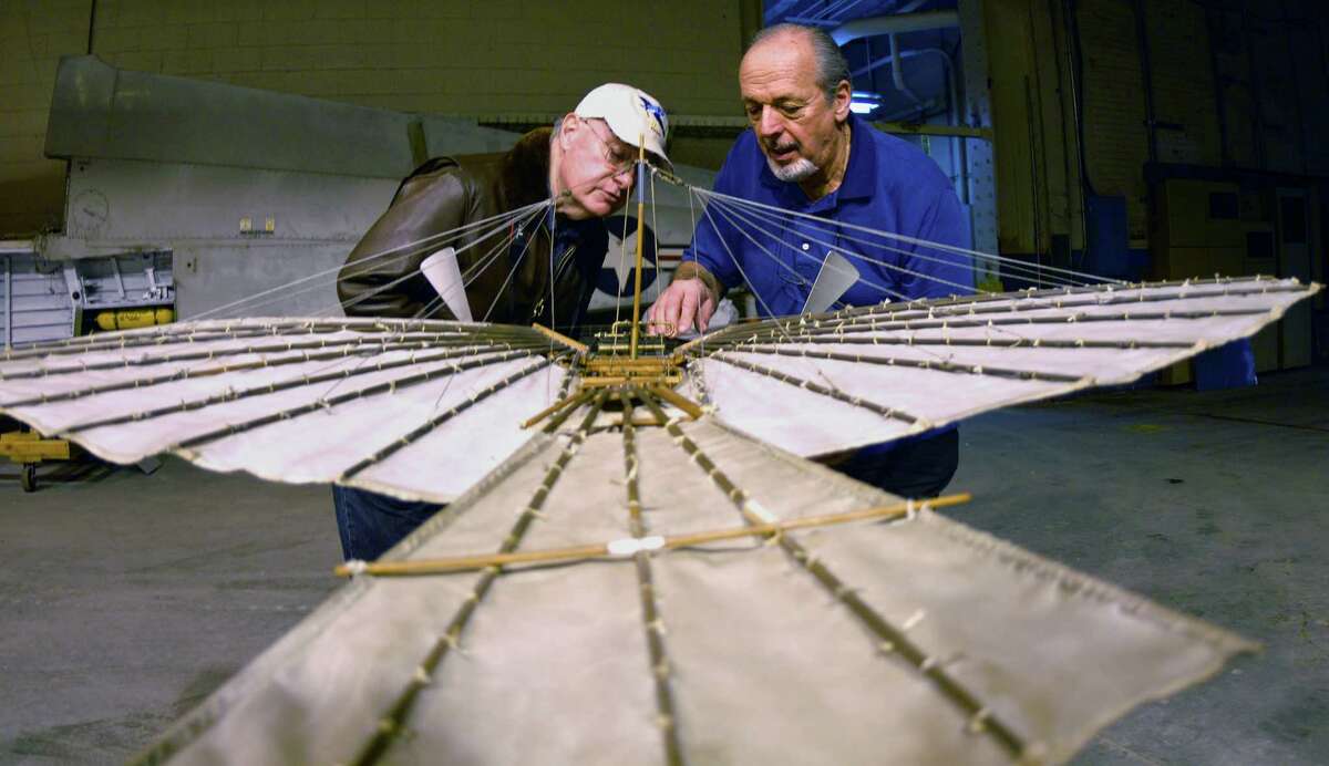 Connecticut Air and Space Center president Gene Madara and Andy Kosch, board of directors member work with a model of Gustave Whitehead's plane at the center in Stratford, Conn. on Tuesday March 12, 2013. The model was constructed by the late Bill Wargo. Kosch helped build and fly the replica, is the president of the project. For the 100th anniversary edition of Jane's All the World Aircraft, Whitehead's flyer will be given credit as the first operational heavier-than-air aircraft.