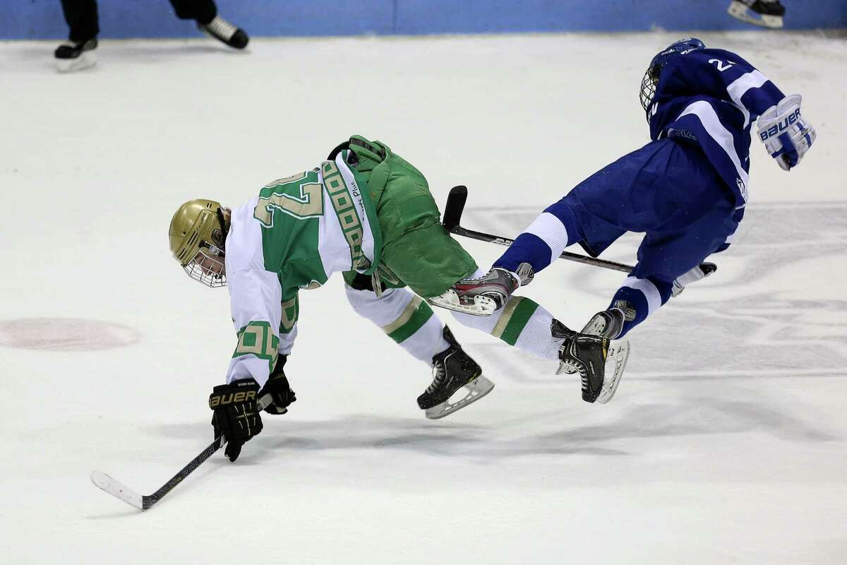 Mike Ross Connecticut Post freelance -Notre Dame of West Haven #24 Eric Austin and Darien High School's #24 Dillion Fitzpatrick collide during first period action of Wednesday evening CIAC State Semifinals.