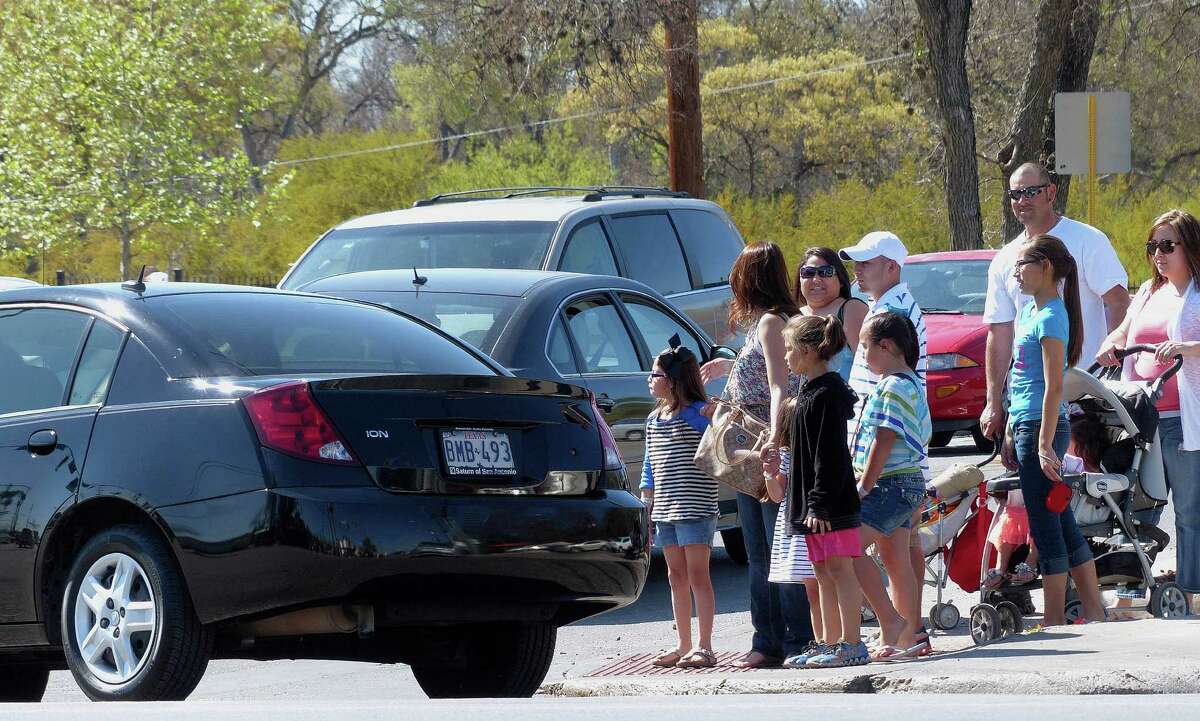 People wait to cross the intersection at Broadway and Mulberry on Wednesday, March 13, 2013. The presence of Brackenridge Park, Kitty Park and the Lions Field playground in the area, coupled with the rerouting of traffic that would normally travel on Hildebrand to Mulberry, have caused congestion.