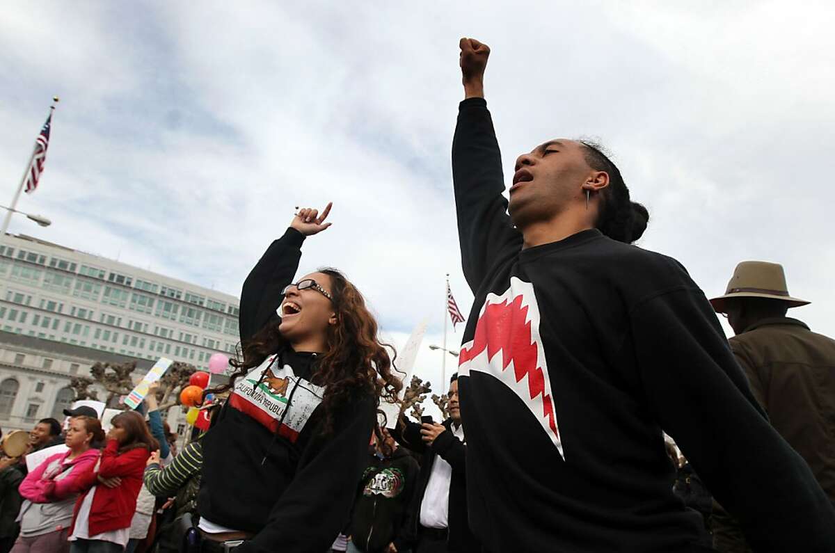 Vanessa Taito and Spencer Pulu took part in a City College of San Francisco rally outside San Francisco City Hall during a protest over budget cuts and accreditation problems Thursday, March 14, 2013, in San Francisco Calif.