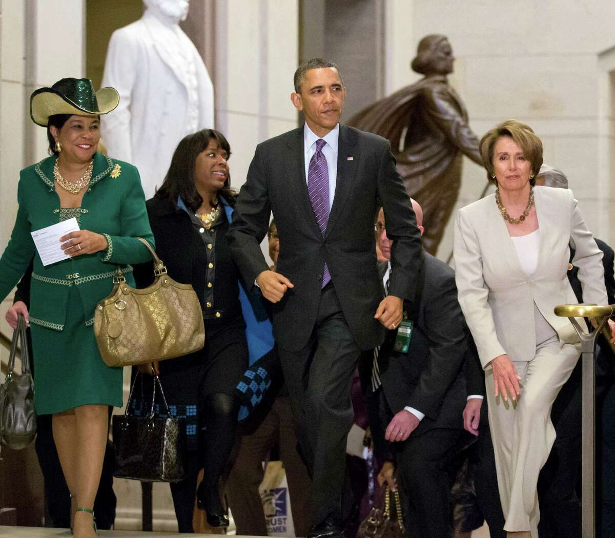 President Barack Obama and House Minority Leader Nancy Pelosi, D-Calif., leave a meeting with House Democrats at the Capitol, in Washington, Thursday, March 14, 2013. At far left is Rep. Frederica Wilson, D-Fla., with Rep. Terri Sewell, D-Ala., second from left. (AP Photo/J. Scott Applewhite)