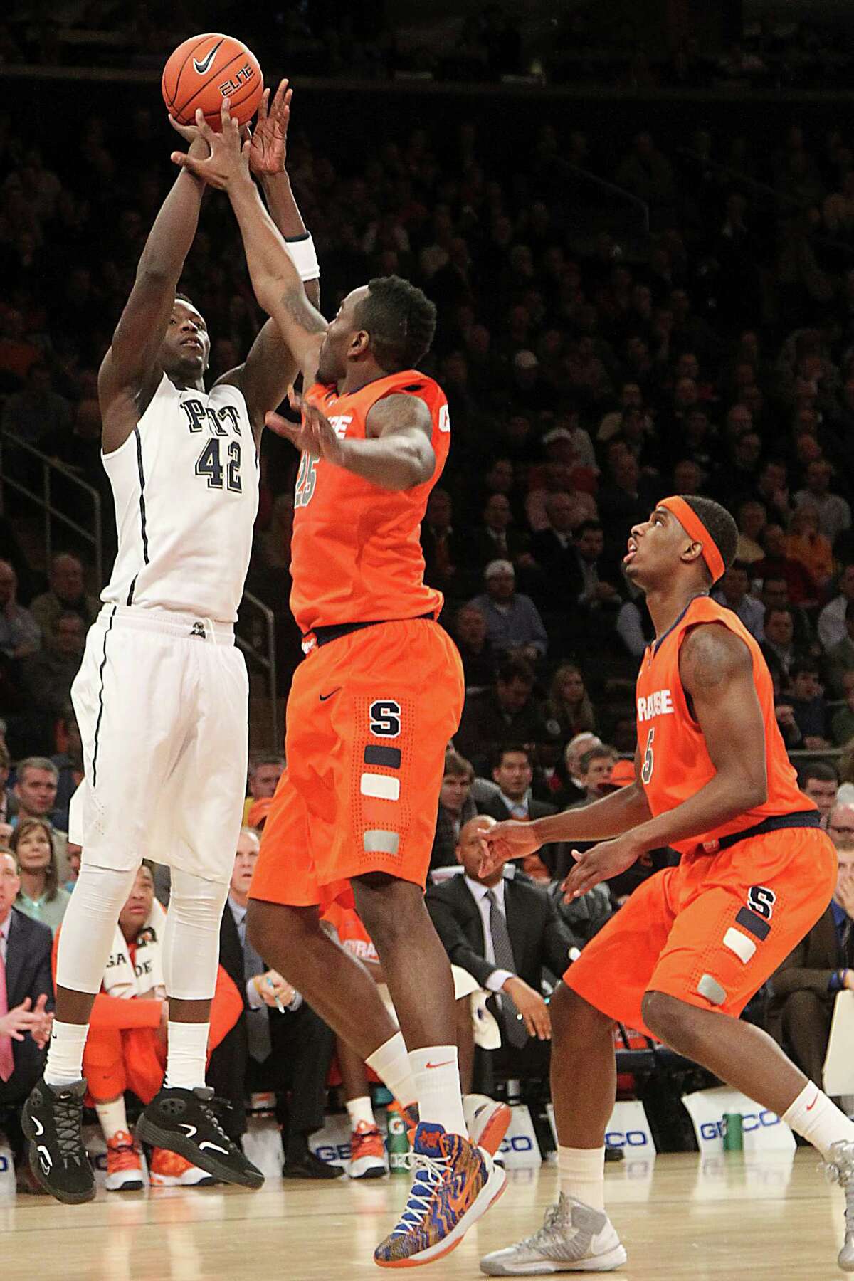 Pittsburgh's Talib Zanna (42) goes up past Syracuse's Rakeem Christmas (25) and C.J. Fair during the first half of an NCAA college basketball game at the Big East Conference tournament, Thursday, March 14, 2013 in New York. (AP Photo/Mary Altaffer)