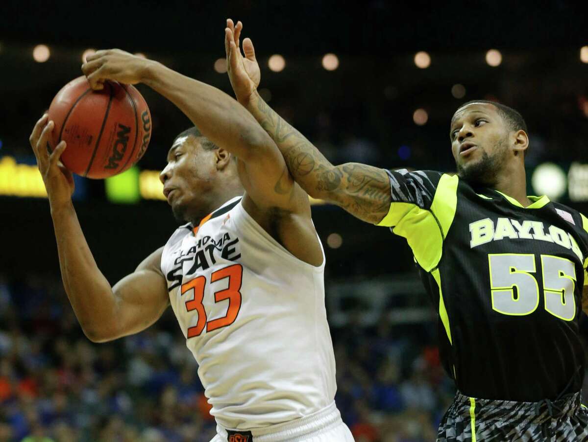 Oklahoma State's Marcus Smart pulls down a rebounds against Baylor's Pierre Jackson in the first half of Thursday night's game. The Cowboys won 74-72.