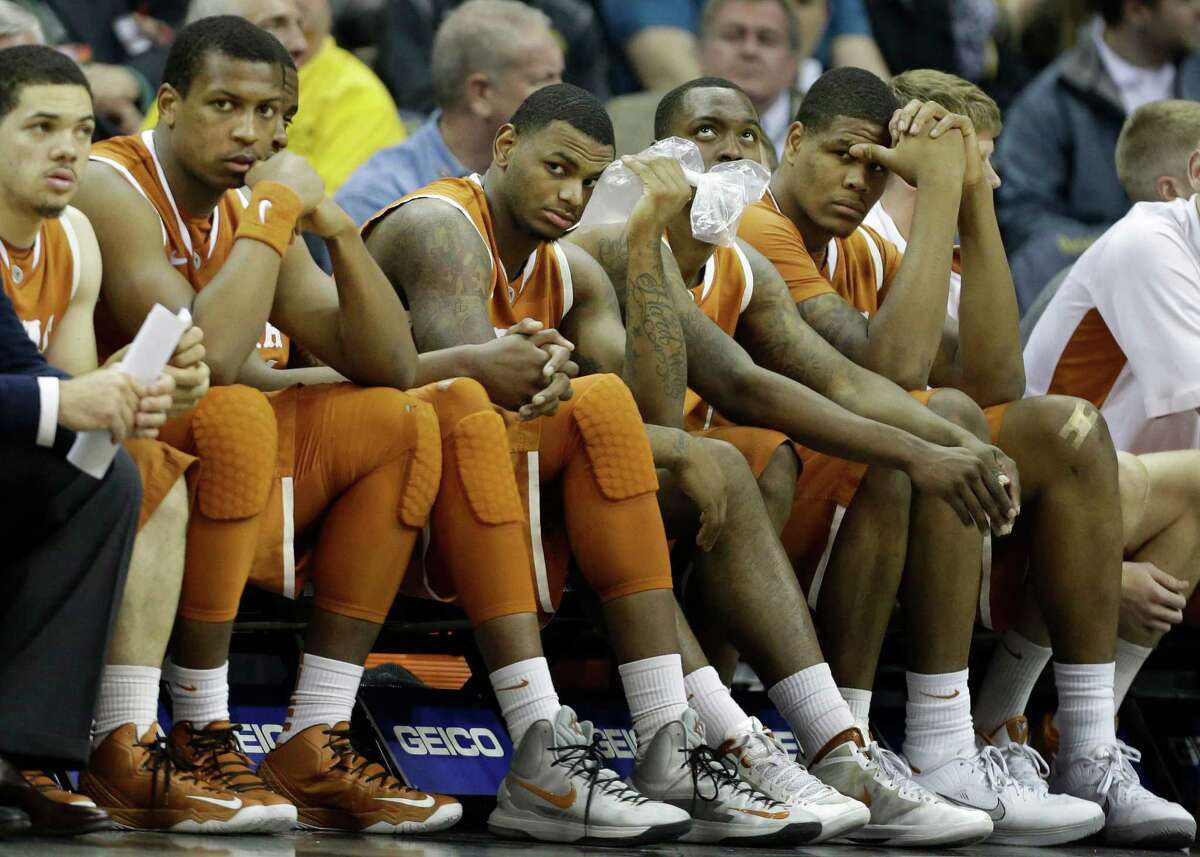 Texas players sit on the bench during the final minutes of an NCAA college basketball game in the Big 12 tournament on Thursday, March 14, 2013, in Kansas City, Mo. Kansas State defeated Texas 66-49. (AP Photo/Orlin Wagner)