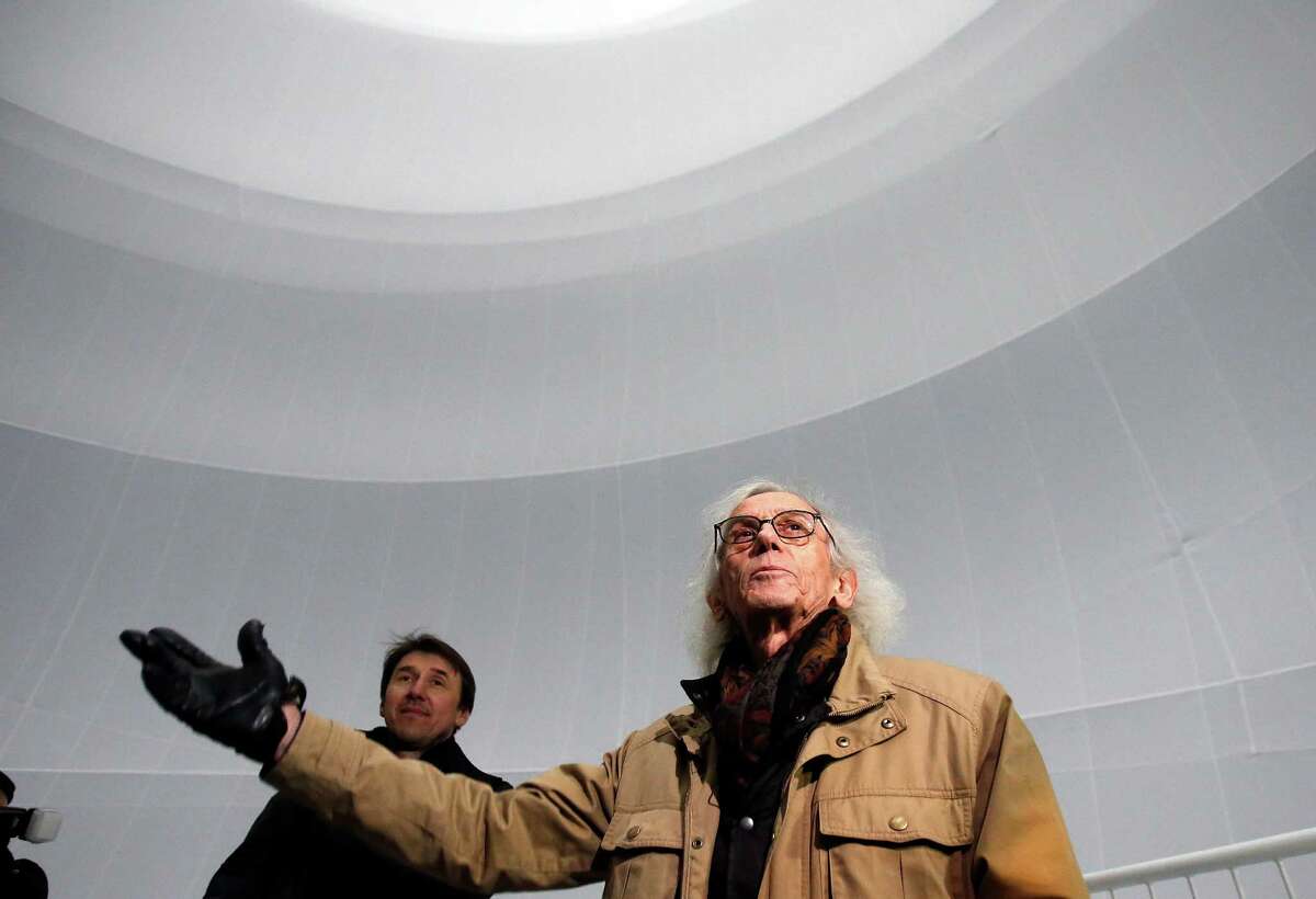 Bulgarian artist Christo gestures as he poses inside the installation 'Big Air Package' during the unveiling of the installation at the Gasometer in Oberhausen, Germany, Friday, March 15, 2013. Christo's latest monumental sculpture in the interior of the industrial monument can be seen from March 16 until Dec. 30, 2013. (AP Photo/Frank Augstein)