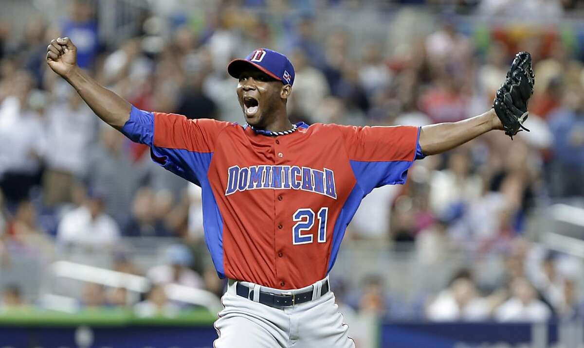 Dominican Republic pitcher Samuel Deduno reacts after striking out United States' Adam Jones to end the first inning of a second-round game of the World Baseball Classic in Miami, Thursday, March 14, 2013. (AP Photo/Wilfredo Lee)