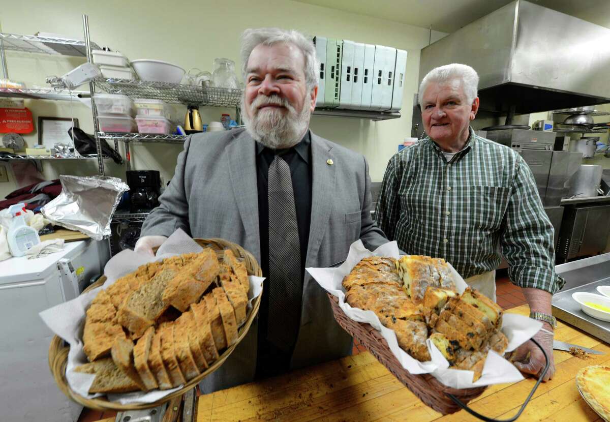 Chef Pat Hale holds tradition brown bread, left and Irish soda bread right before the St. Patrick's day celebration March 15, 2013, Albany, N.Y. With Hale is cooking volunteer Ron Guiry. (Skip Dickstein/Times Union)