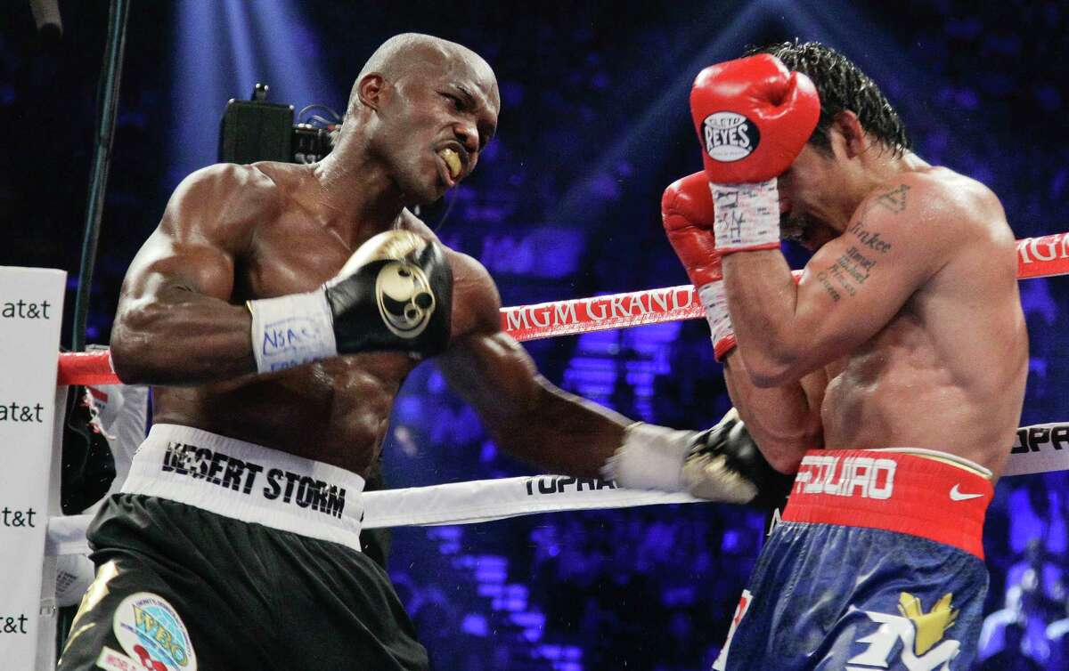 FILE - In this June 9, 2012 file photo, Timothy Bradley lands a punch to the body of Manny Pacquiao in the ninth round of their WBO world welterweight title fight in Las Vegas. He drew criticism, ridicule and even death threats after his split decision over Pacquiao last year. Bradley is ready to start rebuilding his reputation against Russia's Ruslan Provodnikov on Saturday, March 16, 2013. (AP Photo/Julie Jacobson, File)