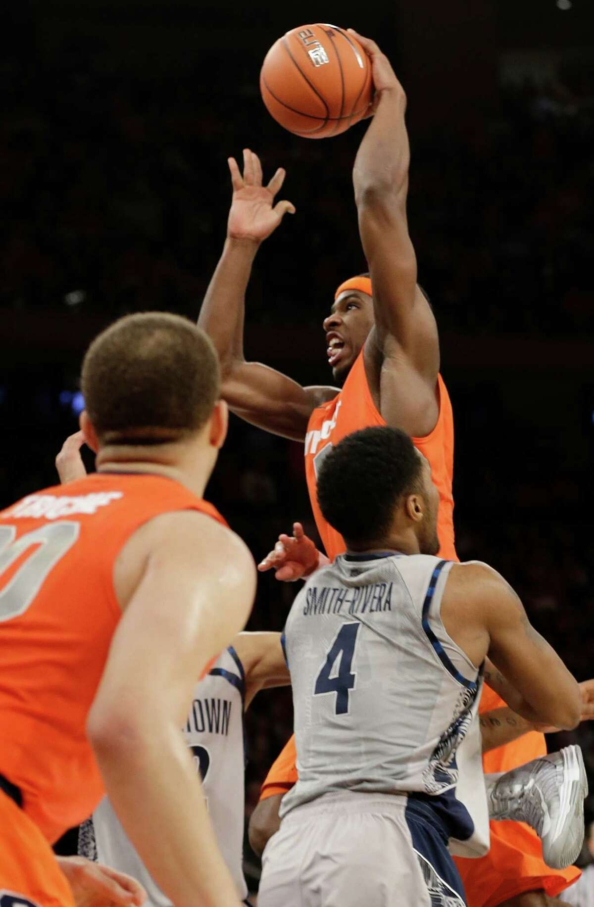 Syracuse's C.J. Fair (5) drives past Georgetown's D'Vauntes Smith-Rivera (4) during the overtime period of an NCAA college basketball game at the Big East Conference tournament Friday, March 15, 2013, in New York. Syracuse won the game 58-55. (AP Photo/Frank Franklin II)