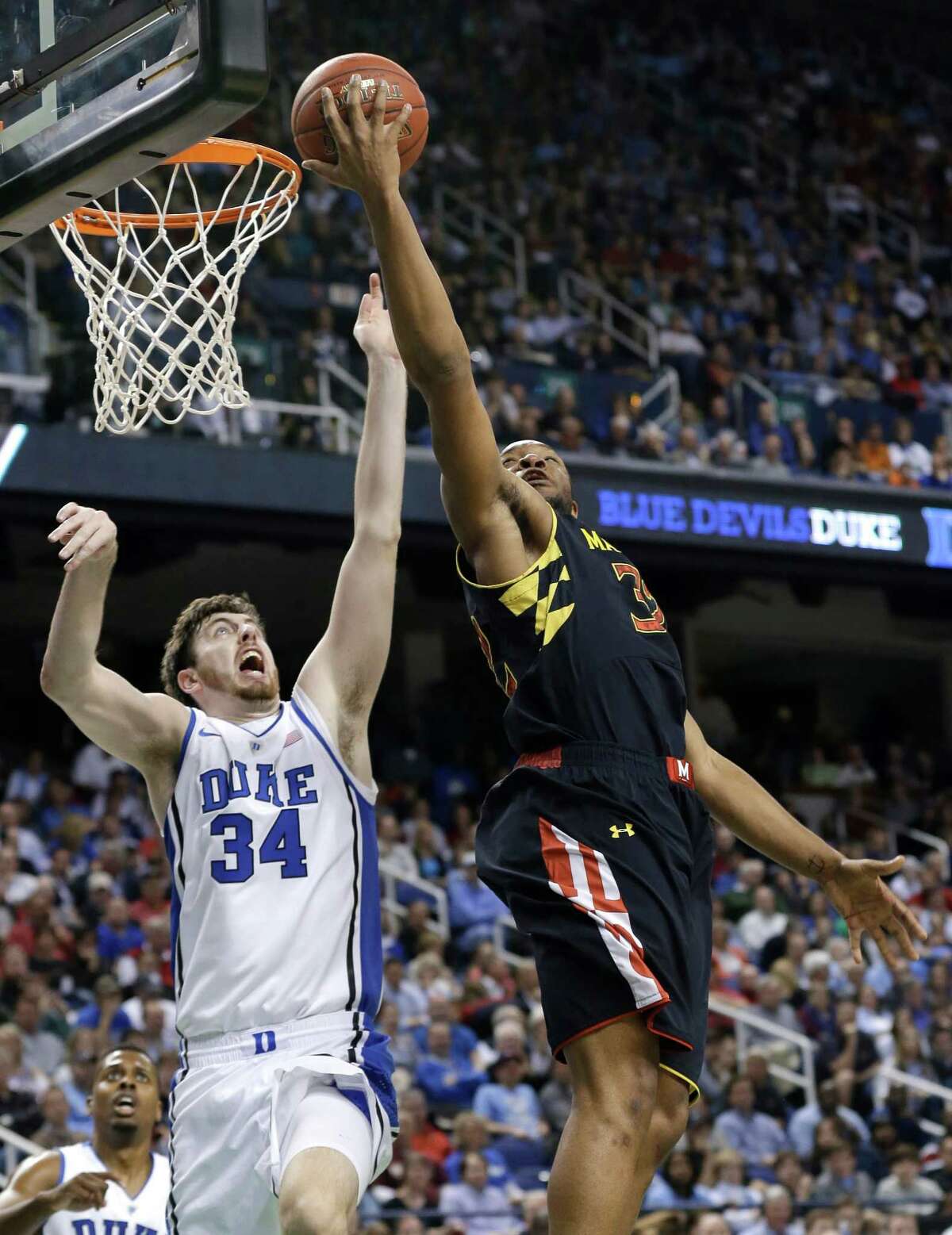 Maryland's Dez Wells, right, shoots over Duke's Ryan Kelly during the first half of an NCAA college basketball game at the Atlantic Coast Conference men's tournament in Greensboro, N.C., Friday, March 15, 2013. (AP Photo/Gerry Broome)