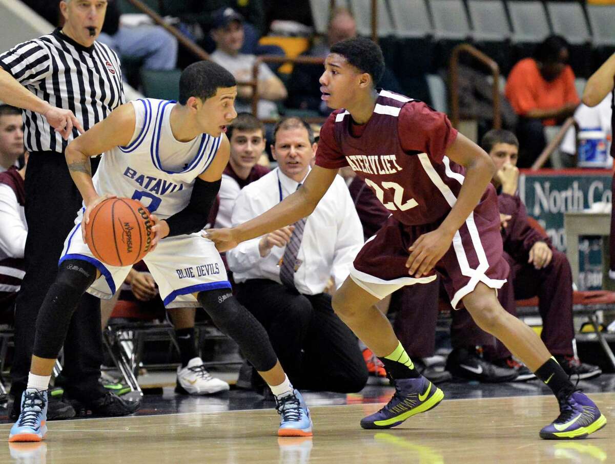 Watervliet's #22 Henassy McConico, at right, guards Batavia's #0 Jalen Smith as Vliet coach Orlando DiBacco, center, looks on during the Class B semifinal at Glens Falls Civic Center Friday March 15, 2013. (John Carl D'Annibale / Times Union)