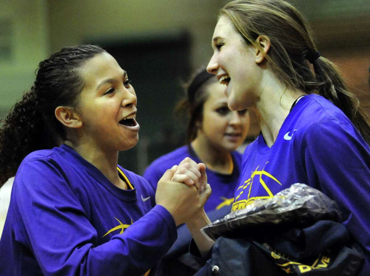 Troy's Kiana Patterson, left, celebrates with Mary Pattison when they win their Class A semifinal state basketball game against Pittsford Mendon Friday, March 15, 2013, at Hudson Valley Community College in Troy, N.Y. (Cindy Schultz / Times Union)