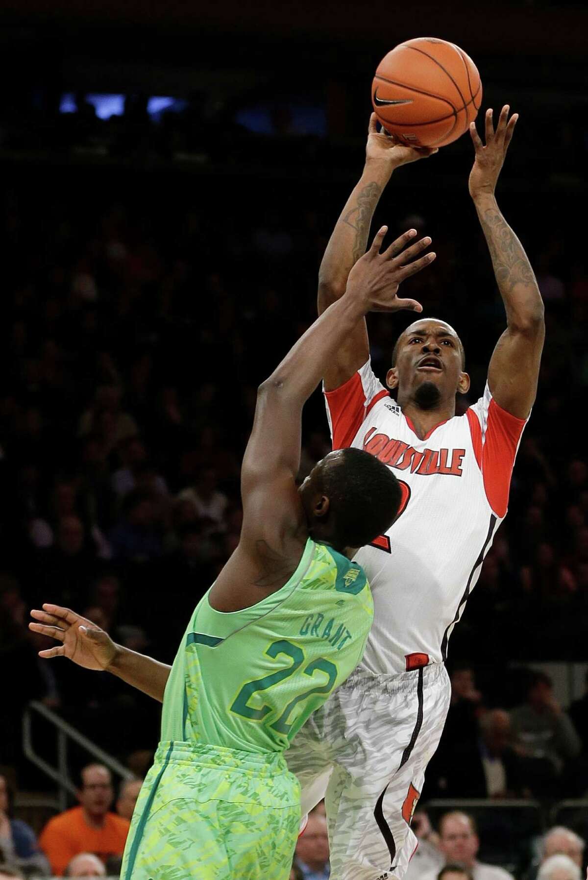 Louisville's Russ Smith (2) shoots over Notre Dame's Jerian Grant (22) during the first half of an NCAA college basketball game at the Big East Conference tournament Friday, March 15, 2013, in New York. (AP Photo/Frank Franklin II)