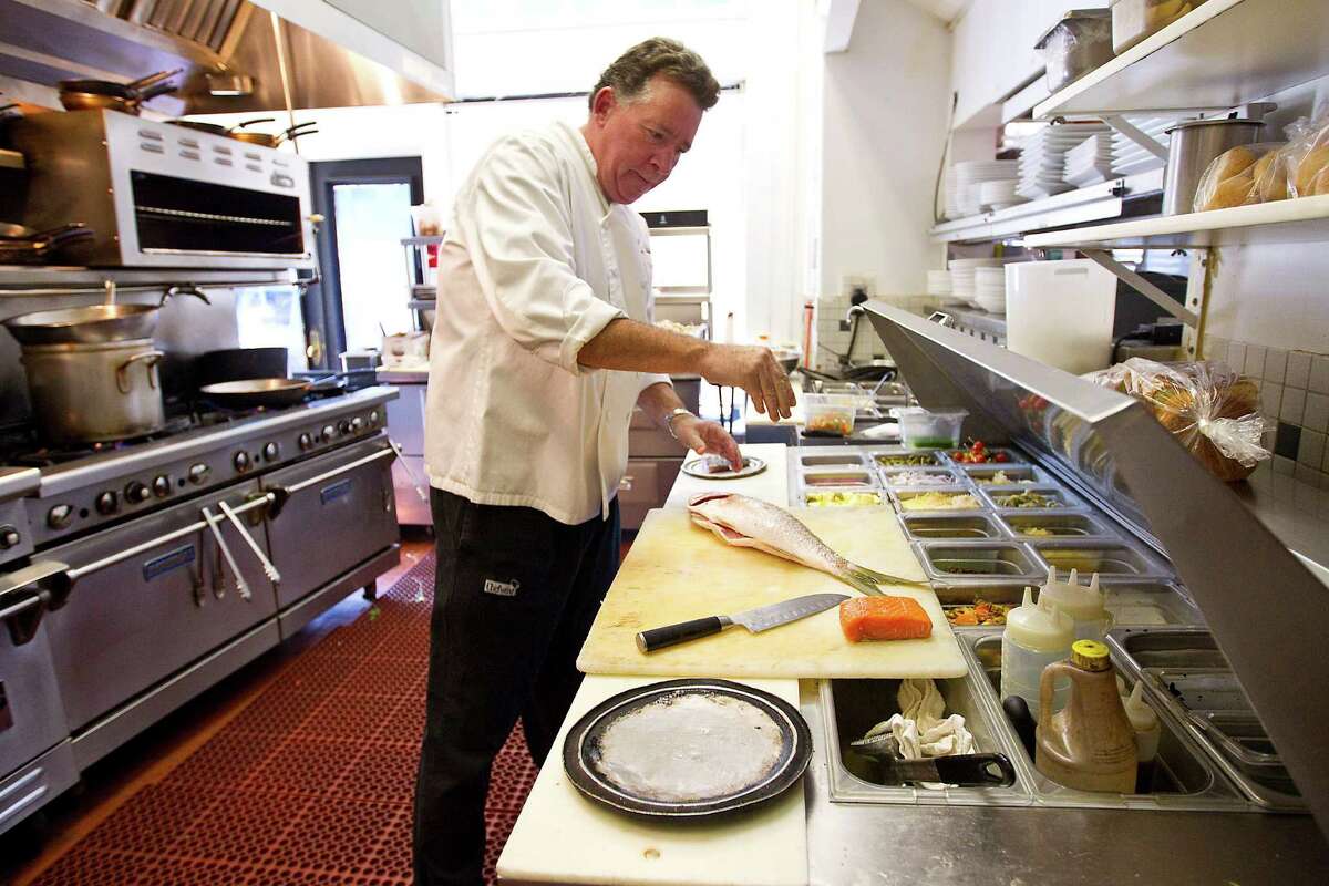 Mockingbird Bistro Chef John Sheely prepares a Barramundi fish at Mockingbird Bistro, Sheely said it will "be interesting to see how it plays out over the next few years" with so many restaurants opening. "Everything will pop at once, and you'll have a honeymoon period," he said.