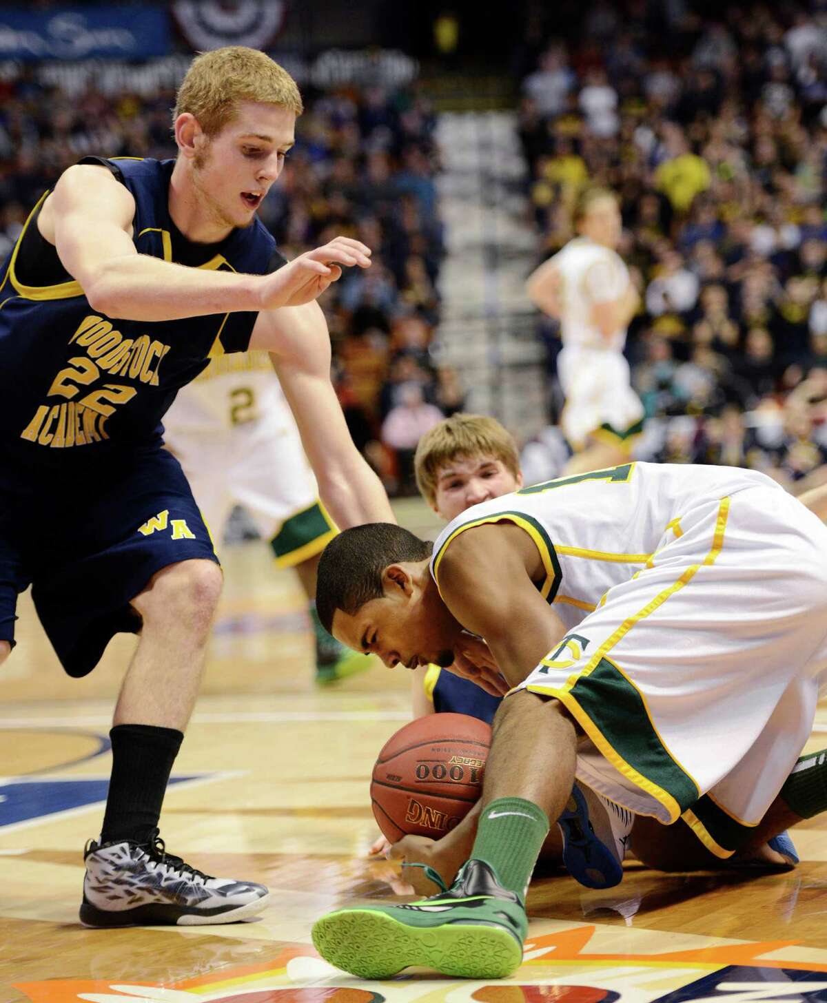 Neno Merritt, Trinity Catholic High School, fights for a loose ball in the CIAC class L boys basketball championship game against Woodstock Academy at Mohegan Sun Arena in Uncasville, Conn. on Saturday, March 16, 2013.