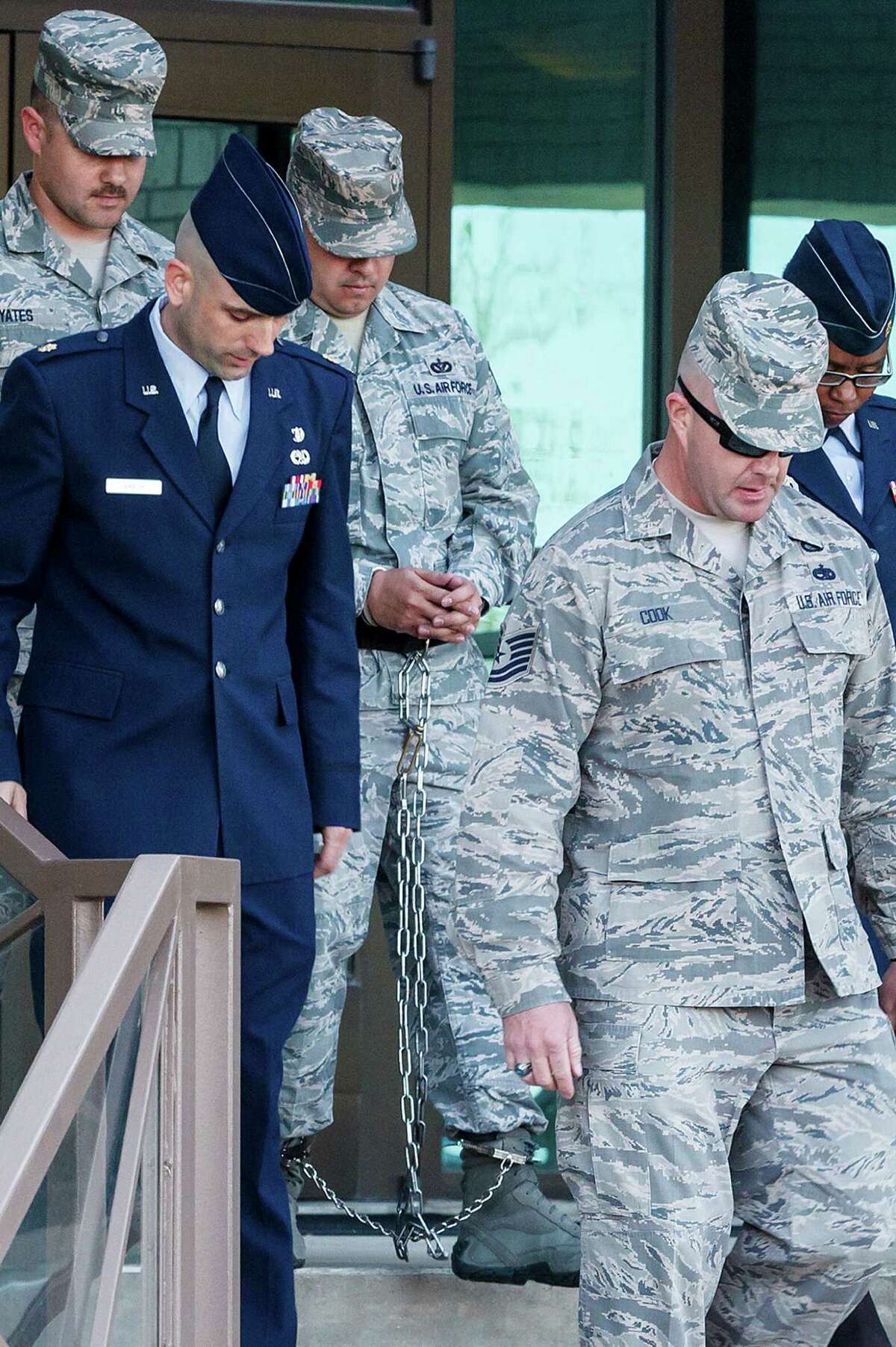 A shackled Staff Sgt. Eddy Soto (center) is escorted out of the 37th Training Wing headquarters building at Lackland after his Article 32 hearing on Saturday, March 16, 2013. Soto is the second basic training instructor to be found guilty of rape. He was also accused of having an "unprofessional relationship" with a female trainee and of sexually assaulting two female former trainees.