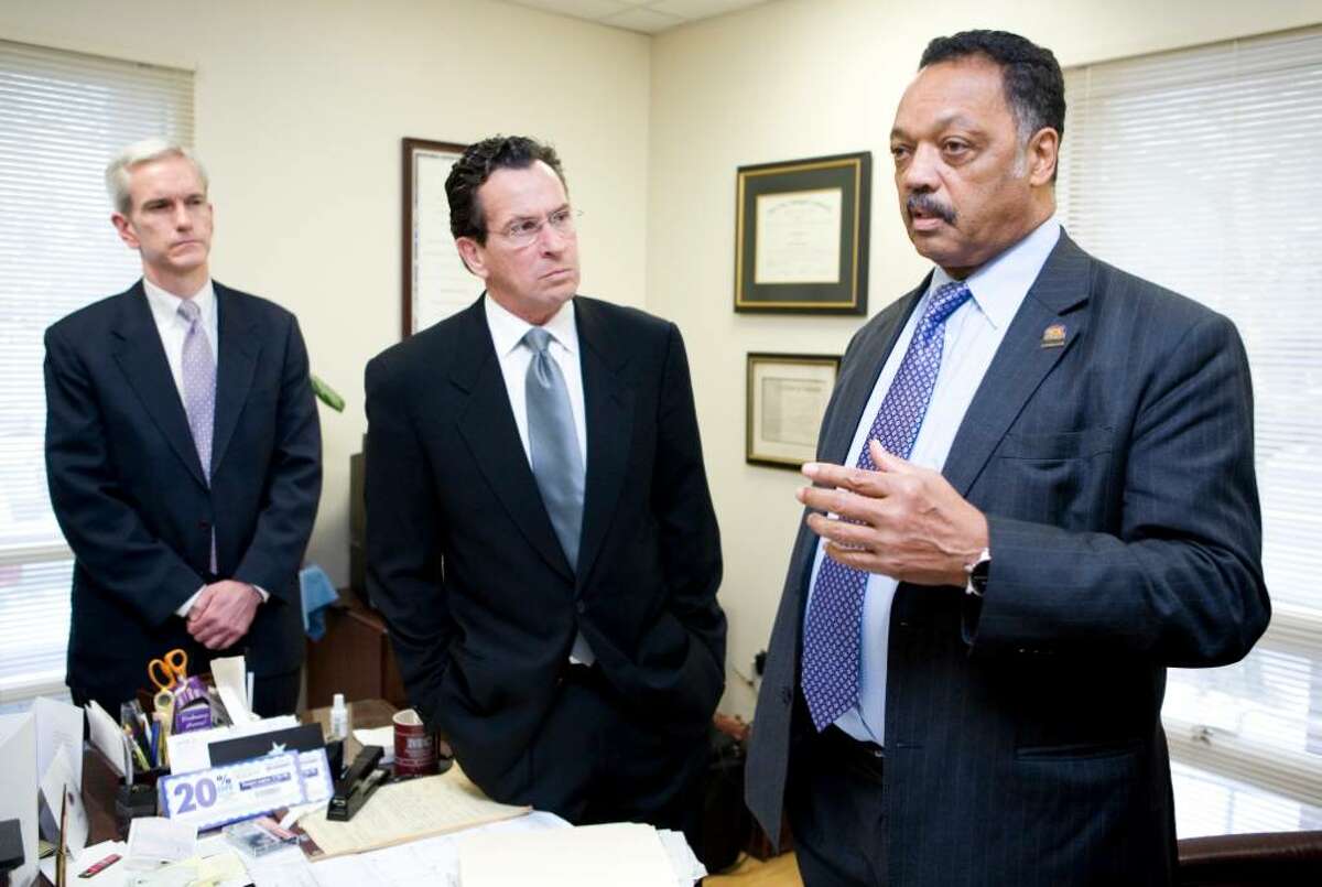 The Rev. Jesse Jackson, right, talks to the press before speaking to a group at the Faith Tabernacle Baptist Church in Stamford on the subject of economic exclusivity. With him is Senator Andrew McDonald, left, and former Stamford mayor Dannel Malloy.
