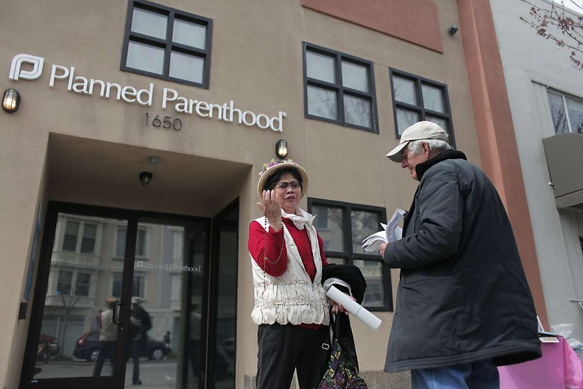 Ron Konopaski, right, speaks with a woman in front of Planned Parenthood in San Francisco, Calif. on Friday, March 15. San Francisco Supervisor David Campos wants to put a 25-foot bubble around reproductive health care facilities to protect clients from aggressive protesters.