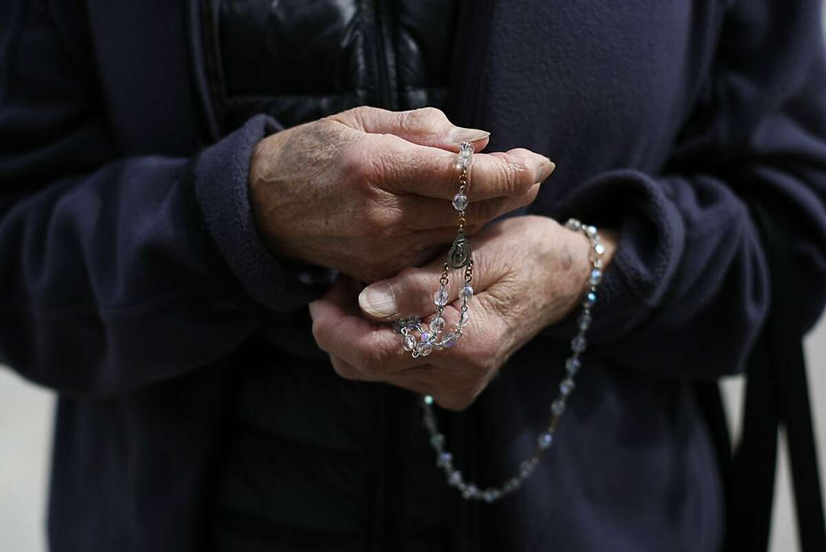 A woman prays the Rosary in front of Planned Parenthood on 1650 Valencia St. in San Francisco, Calif. on Friday, March 15. San Francisco Supervisor David Campos wants to put a 25-foot bubble around reproductive health care facilities to protect clients from aggressive protesters.