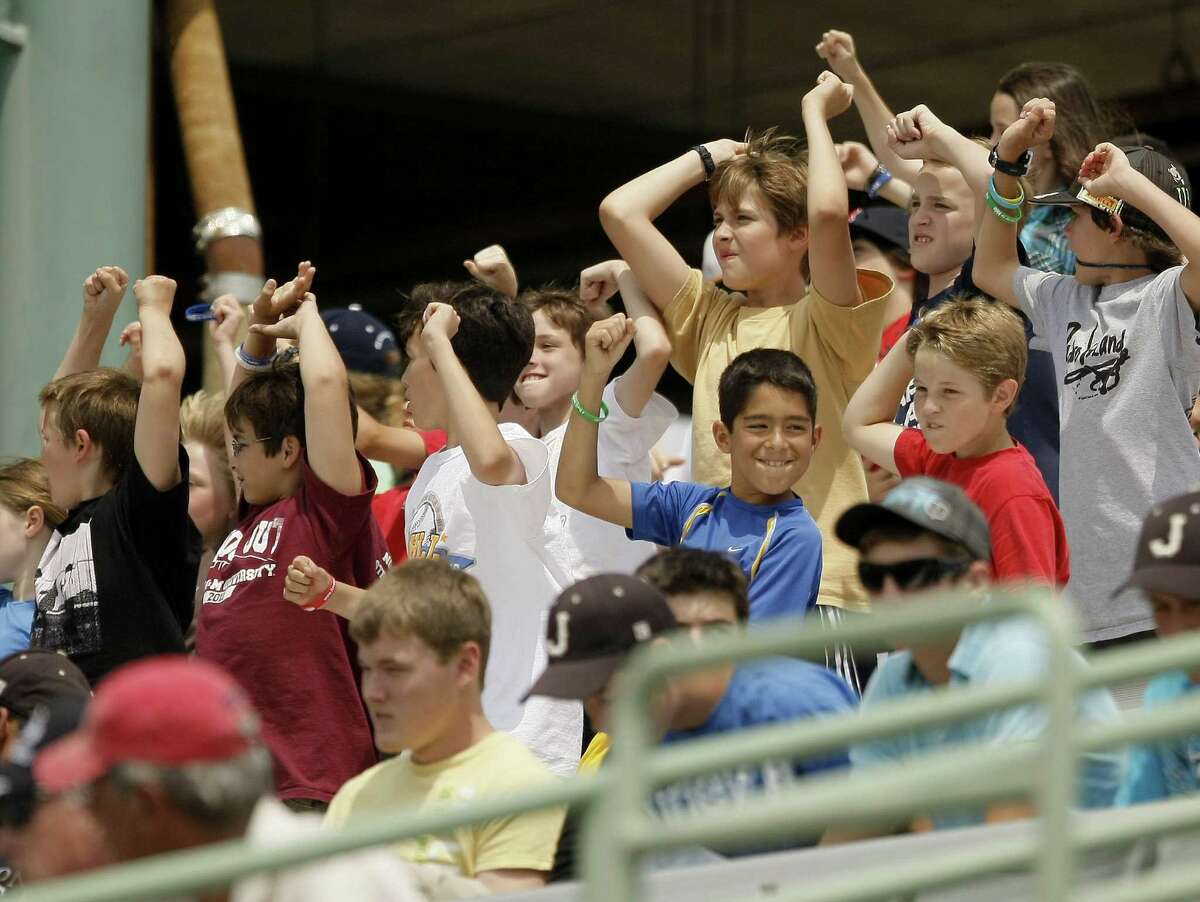 Students cheer during a minor league baseball game between the San Antonio Missions and the Corpus Christi Hooks. A soldier writes about how an act of kindness by a minor league ball player helped his young son while the solider was away.