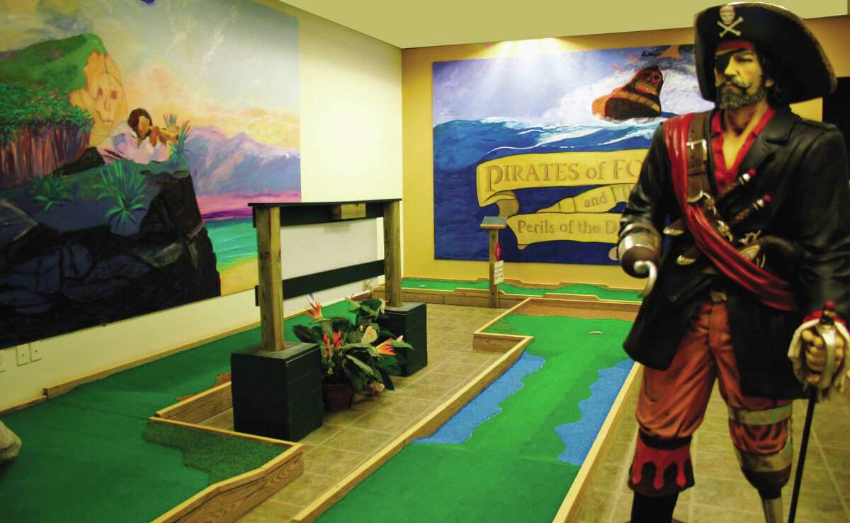 Jill Harrington Nichols loves a challenge, painting eight large scale "black-light" pirate murals at the 18-hole mini-golf attraction at the Batting Cage in the Black Rock section of Bridgeport.