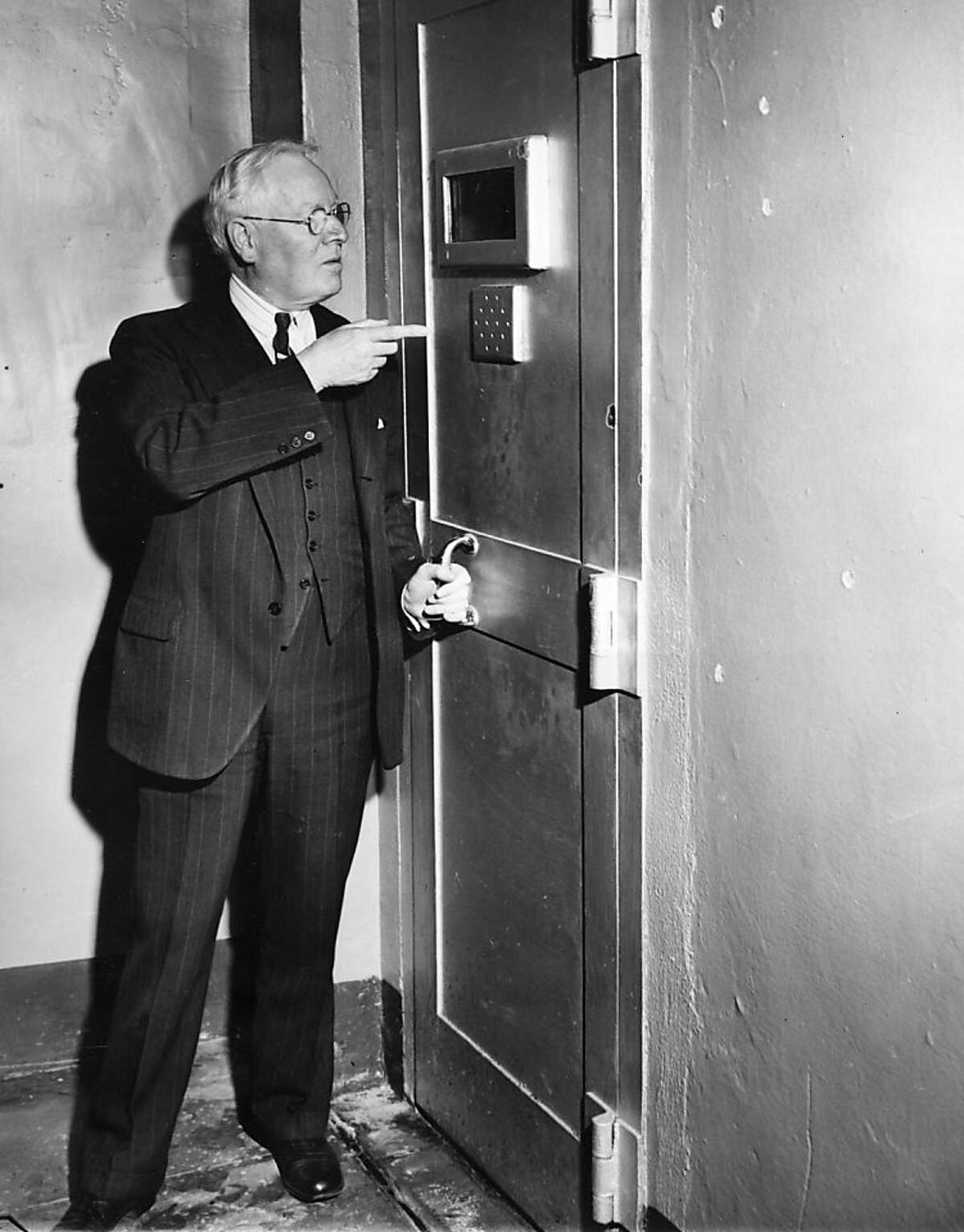 恶魔岛的监狱长詹姆斯·约翰斯顿指着主牢房的门，这扇门阻止了暴乱的囚犯逃跑，因为一名被暴乱分子抓住的警卫把钥匙扔了。暴乱于1946年5月4日结束。