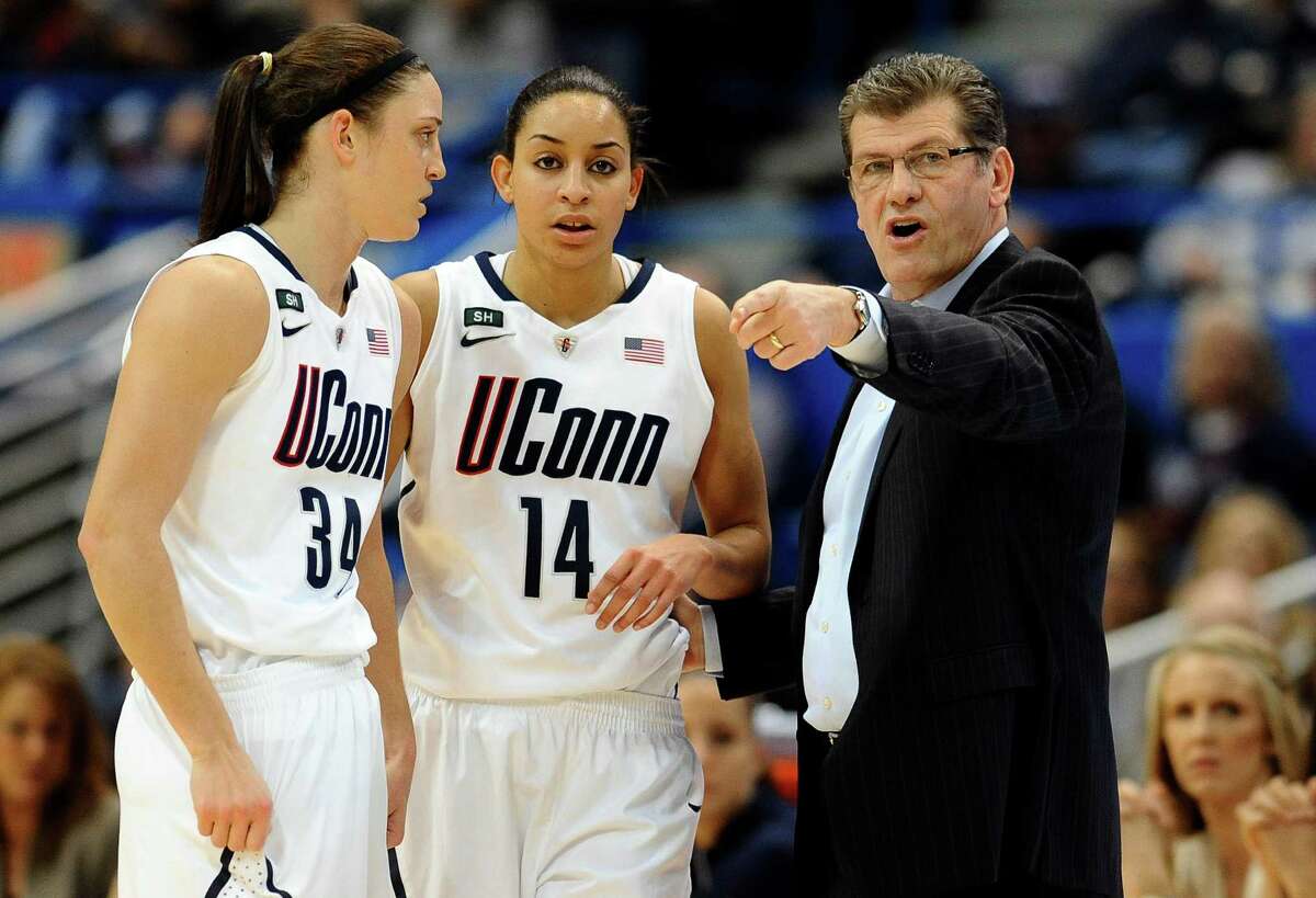 FILE - In this March 11, 2013, file photo, Connecticut head coach Geno Auriemma, right, talks with Kelly Faris (34) and Bria Hartley (14) in the first half of an NCAA college basketball game against Syracuse in the semifinals of the Big East Conference tournament in Hartford, Conn. Connecticut was announced Monday, March 18, to join Baylor, Stanford and Notre Dame as a No. 1 seed in the women's tournament, marking the second straight season those four schools were the top seeds. (AP Photo/Jessica Hill, File)