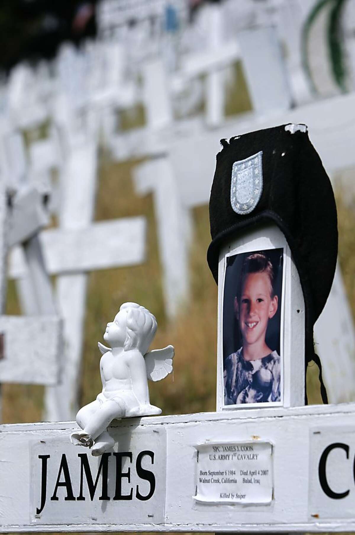 Mementos are affixed to a memorial cross on a hillside in Lafayette, Calif. on Friday, March 15, 2013. Survivors of some soldiers have adopted a cross in memory of their loved one. Anti-war activists erected the monument in late 2006 as a tribute to soldiers who died in the Iraq and Afghanistan wars. Tuesday marks the 10th anniversary of the war in Iraq.