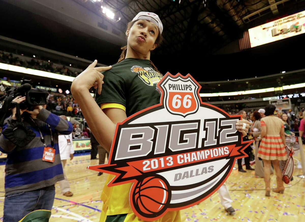Baylor's Brittney Griner, jokes around as she poses for photographers with the 2013 Big 12 Championship sign after their NCAA college basketball championship game against Iowa State in the Big 12 Conference tournament, Monday, March 11, 2013, in Dallas. Baylor won 75-47. (AP Photo/Tony Gutierrez)