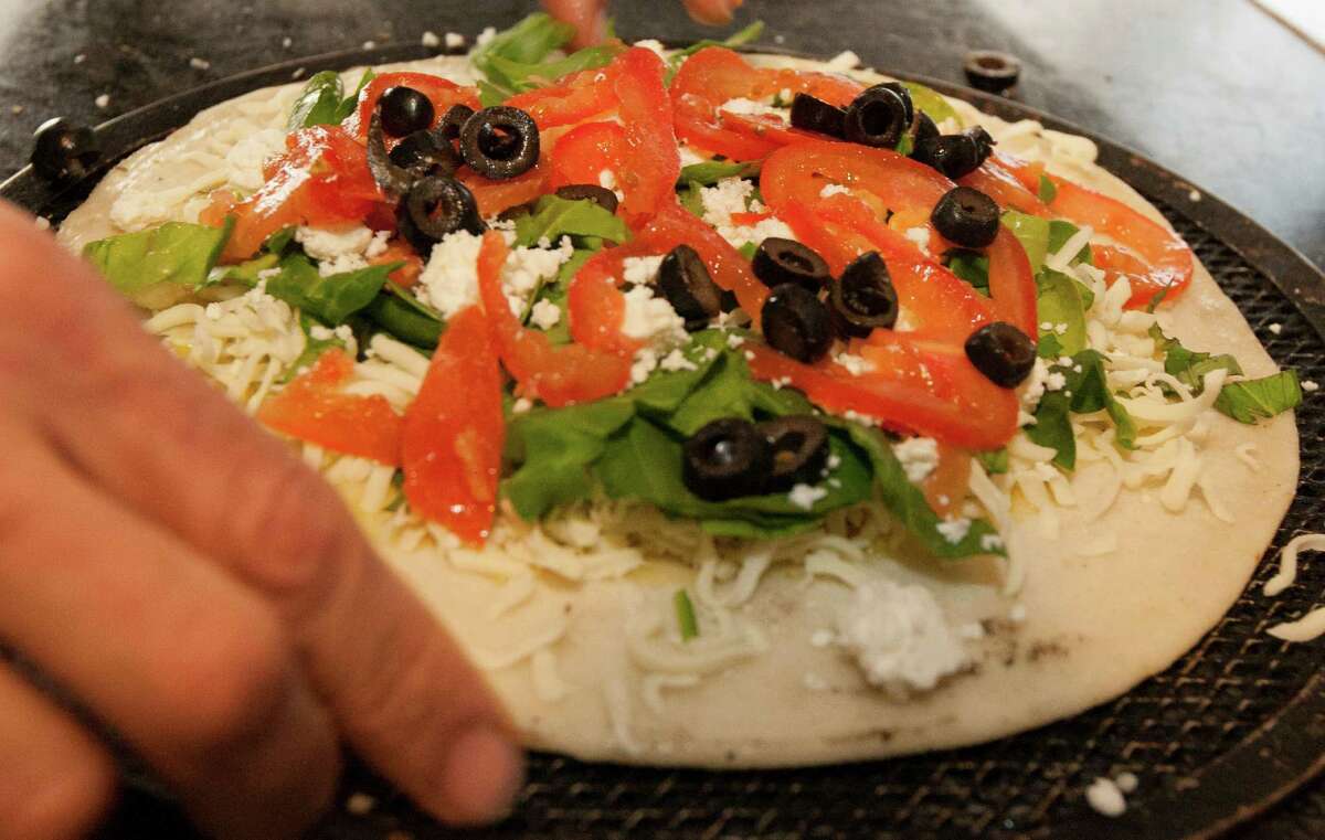 Organic spinach, roma tomatoes and Italian black olives make up this pizza.