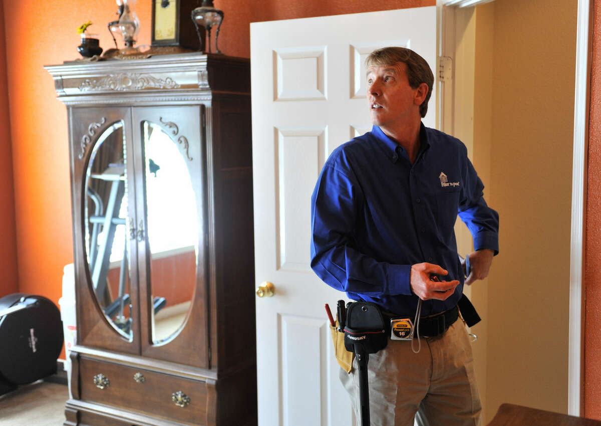 Michael Krumel inspects a home in Helotes. Krumel, 50, who had a long career as a manufacturer's representative for home building products before retiring, now owns a Pillar to Post franchise that specializes in home inspections.