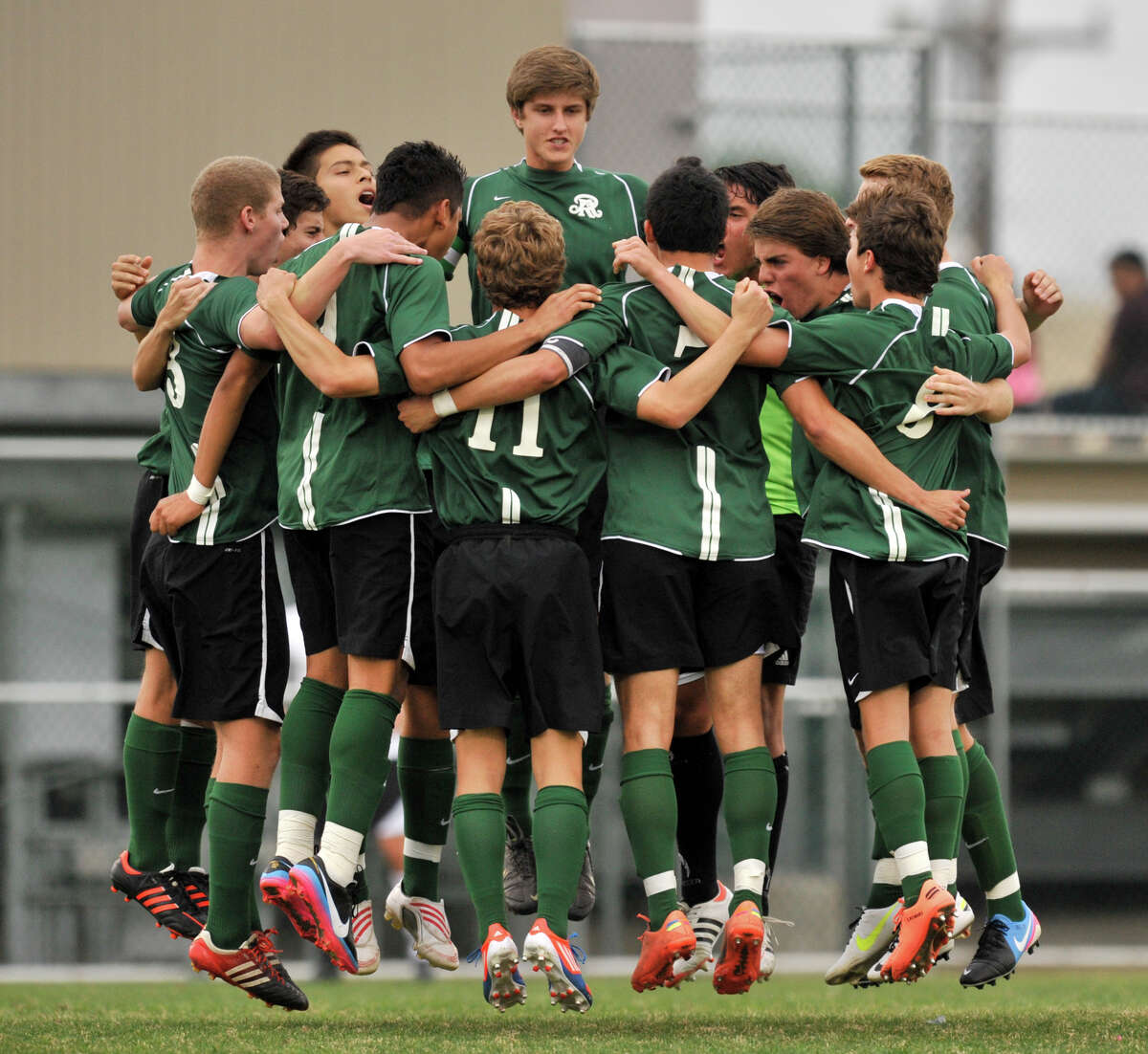Reagan High School soccer players huddle and jump prior to the start of their District 26-5A championship game versus Churchill Tuesday evening.