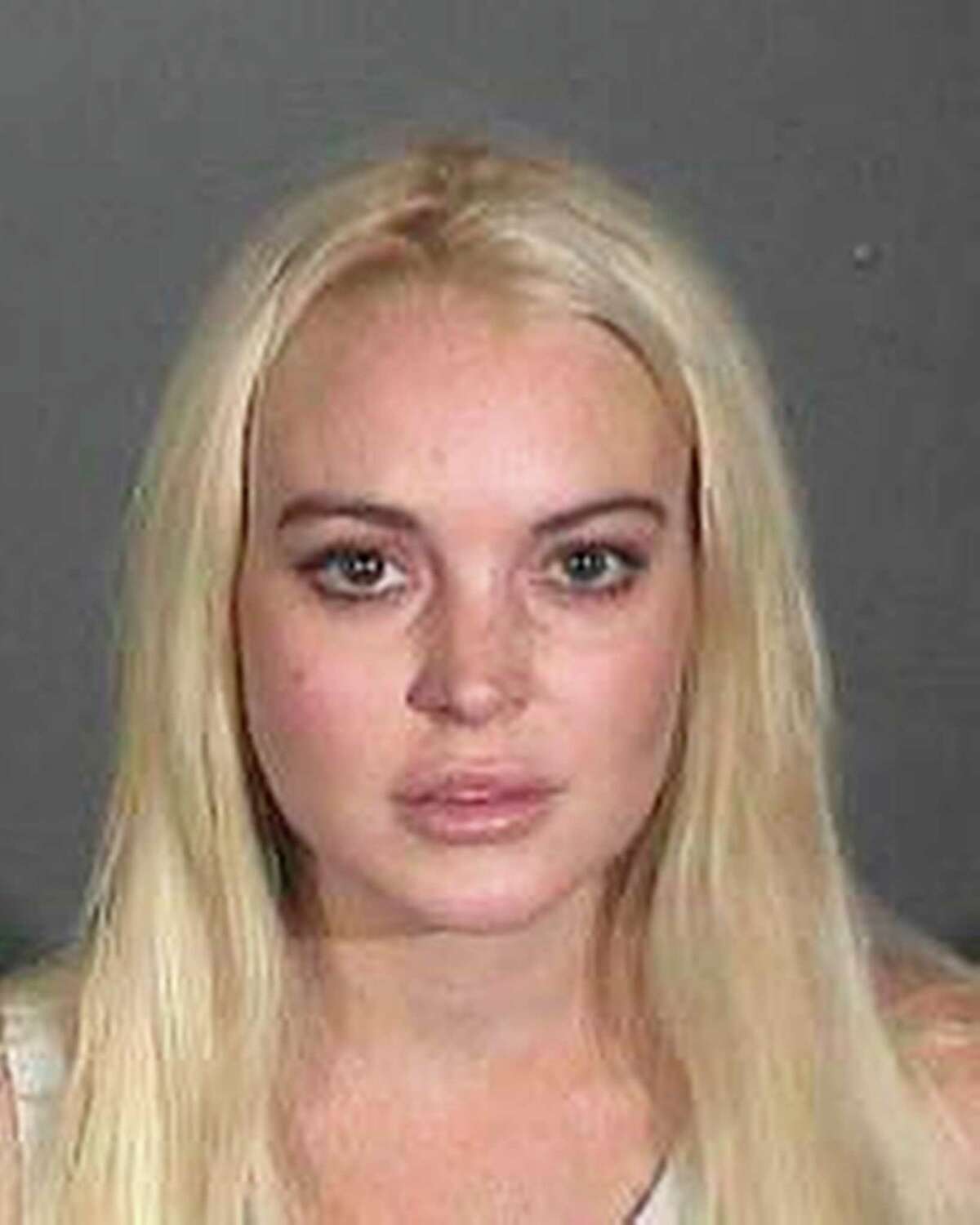 2011: In this booking photo provided by the Los Angeles County Sheriffs Department Actress Lindsay Lohan is shown after she was taken into custody, Wednesday, Oct. 19, 2011. The actress was taken into custody after Superior Court Judge Stephanie Sautner revoked her probation because she was ousted from a community service assignment at a women's shelter.