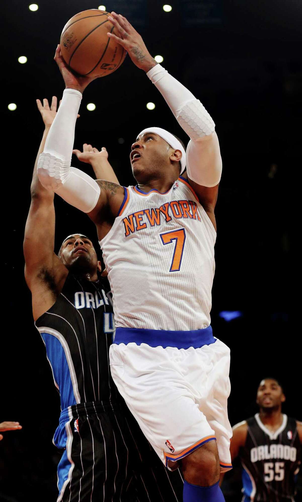 New York Knicks' Carmelo Anthony (7) drives past Orlando Magic's Arron Afflalo (4) during the first half of an NBA basketball game, Wednesday, March 20, 2013, in New York. (AP Photo/Frank Franklin II)