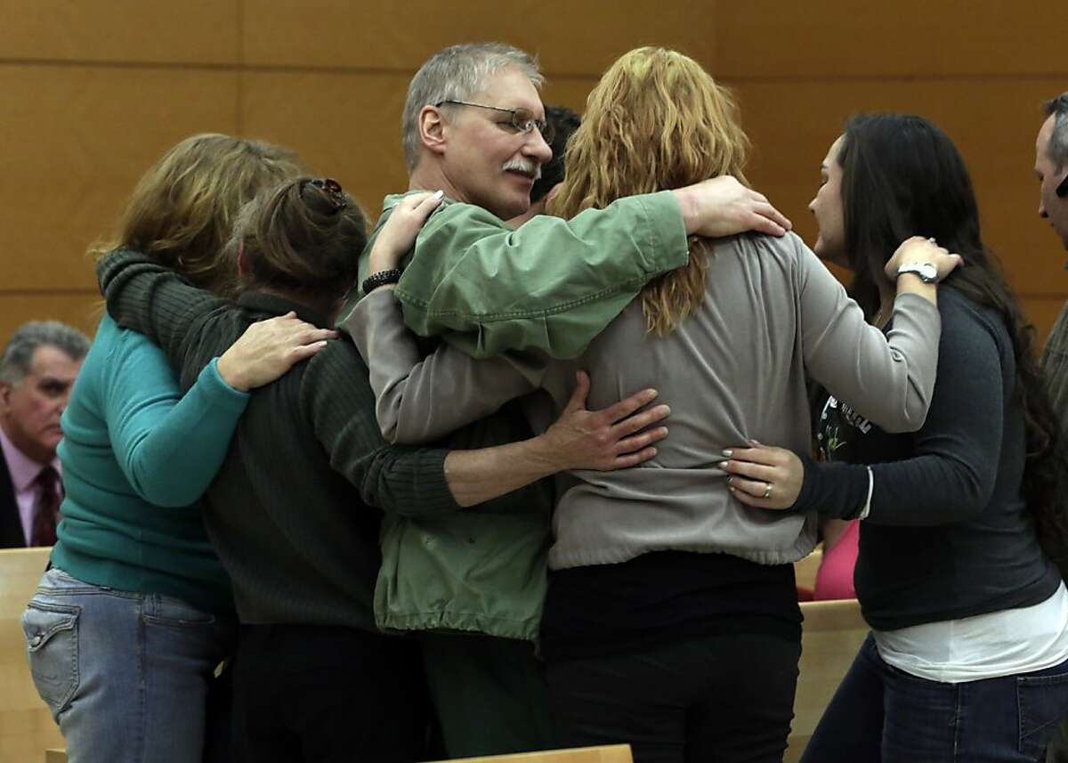 David Ranta, who was convicted of murder in the 1990 cold-blooded slaying of Rabbi Chaskel Werzberger in Brooklyn and has languished behind bars ever since, is hugged by family members after his was freed, in New York state Supreme Court in the Brooklyn borough of New York, Thursday, March 21, 2013. Ranta, 58, who spent more than two decades behind bars, was freed by a New York City judge after a reinvestigation of his case cast serious doubt on evidence used to convict him. (AP Photo/Richard Drew, Pool)