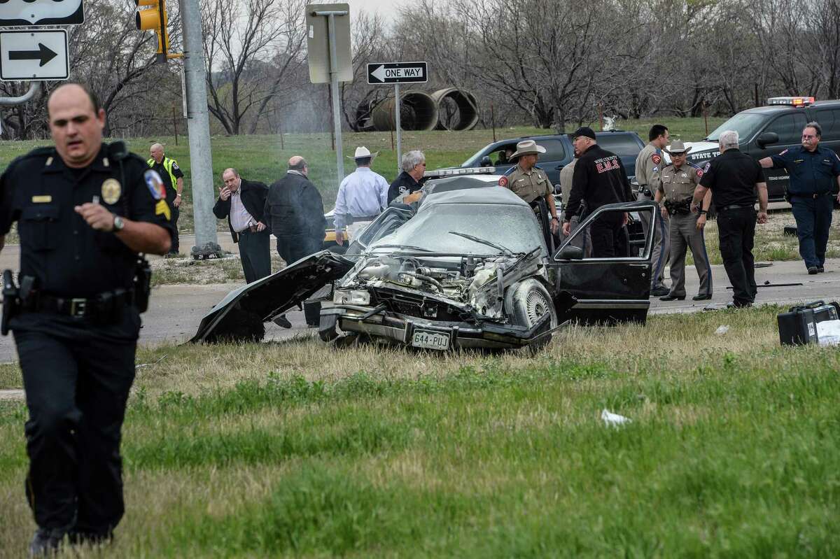 Emergency personnel are on the scene of a crash and shootout with police involving the driver of a black Cadillac with Colorado plates in Decatur, Texas, Thursday, March 21, 2013. The driver led police on a gunfire-filled chase through rural Montague County, crashed his car into a truck in Decatur, opened fire on authorities and was shot, officials said. Texas authorities are checking whether the Cadillac is the same car spotted near the home of Colorado prisons chief Tom Clements, who was shot and killed when he answered the door Tuesday night. (AP Photo/Wise County Messenger, Joe Duty) MANDATORY CREDIT, MAGS OUT