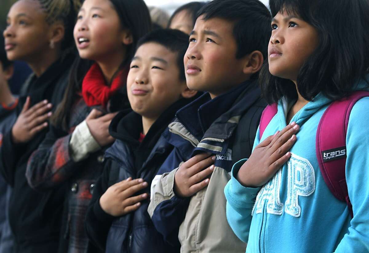 From left, 4th-graders Sanai Mayfield, Adriana Lee, Myron Zhang, David Yu and Ariana Suchranudin recite the Pledge of Allegiance during a bi-weekly assembly at Argonne Elementary School in San Francisco, Calif. on Friday, March 15, 2013.